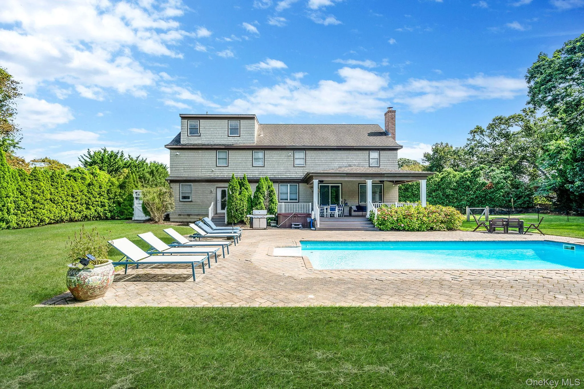 Swimming pool with a yard and a patio area Swimming pool with a yard and a patio area