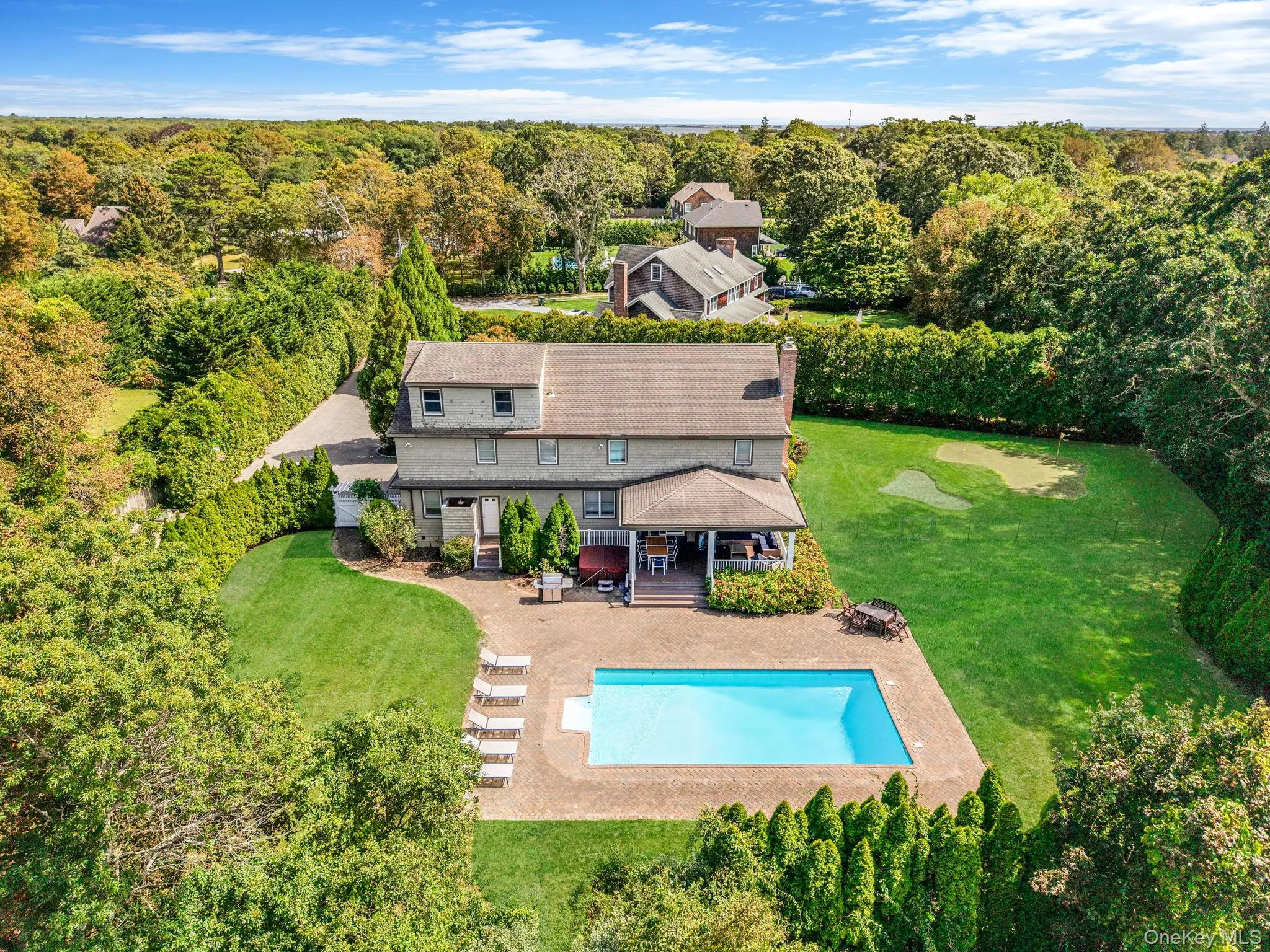 View from above of property with a pool area and a forest View from above of property with a pool area and a forest