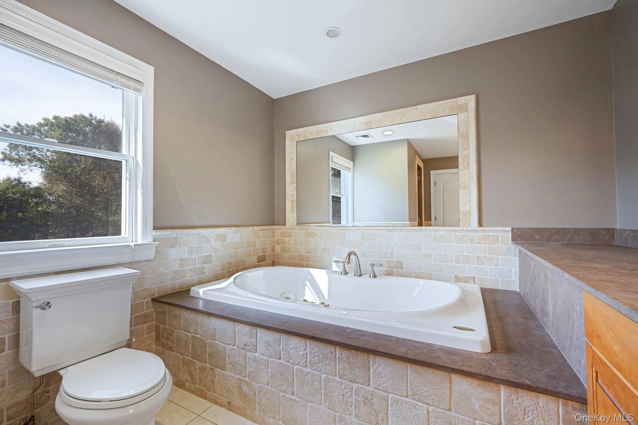 Bathroom with a whirlpool tub and tile patterned flooring Bathroom with a whirlpool tub and tile patterned flooring