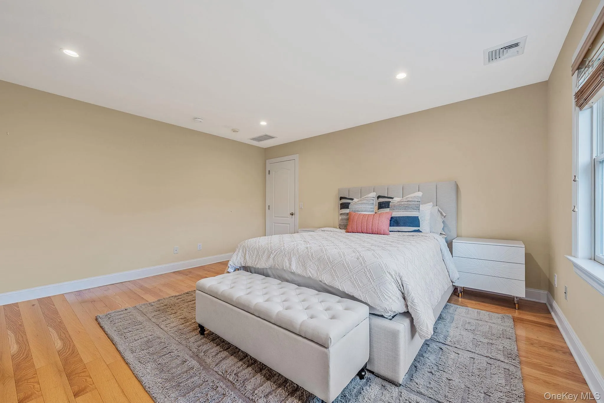 Bedroom with recessed lighting and light wood-style flooring Bedroom with recessed lighting and light wood-style flooring