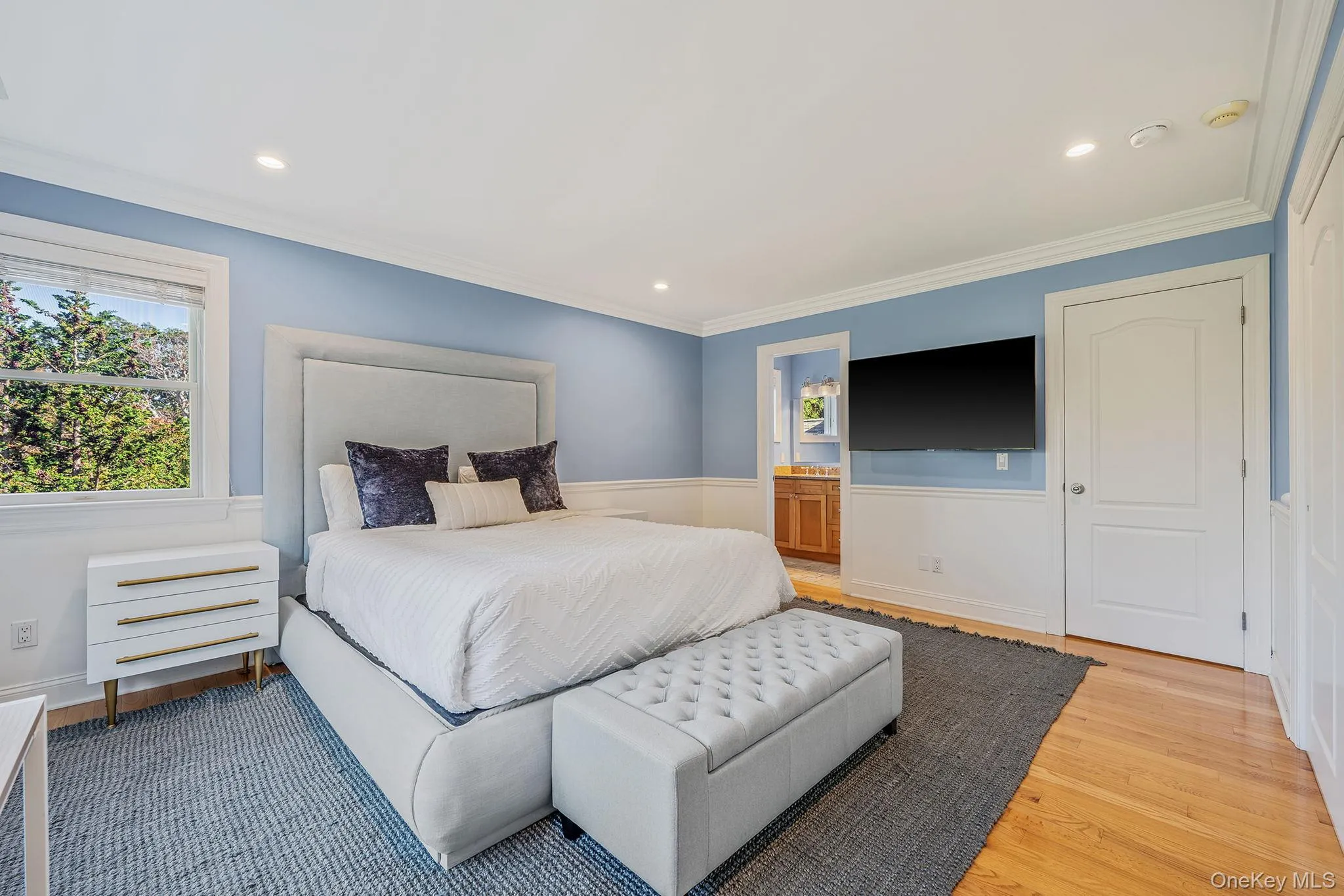 Bedroom with crown molding, wood finished floors, ensuite bath, and recessed lighting Bedroom with crown molding, wood finished floors, ensuite bath, and recessed lighting