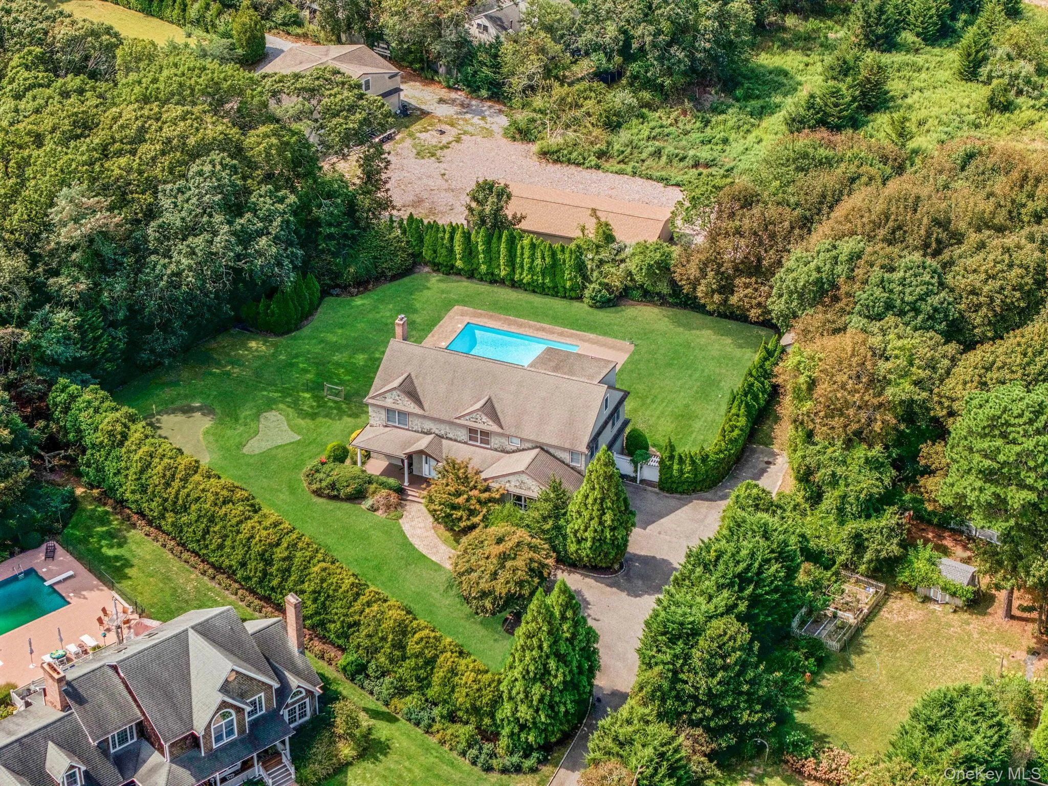 Aerial view of property and surrounding area featuring a pool Aerial view of property and surrounding area featuring a pool