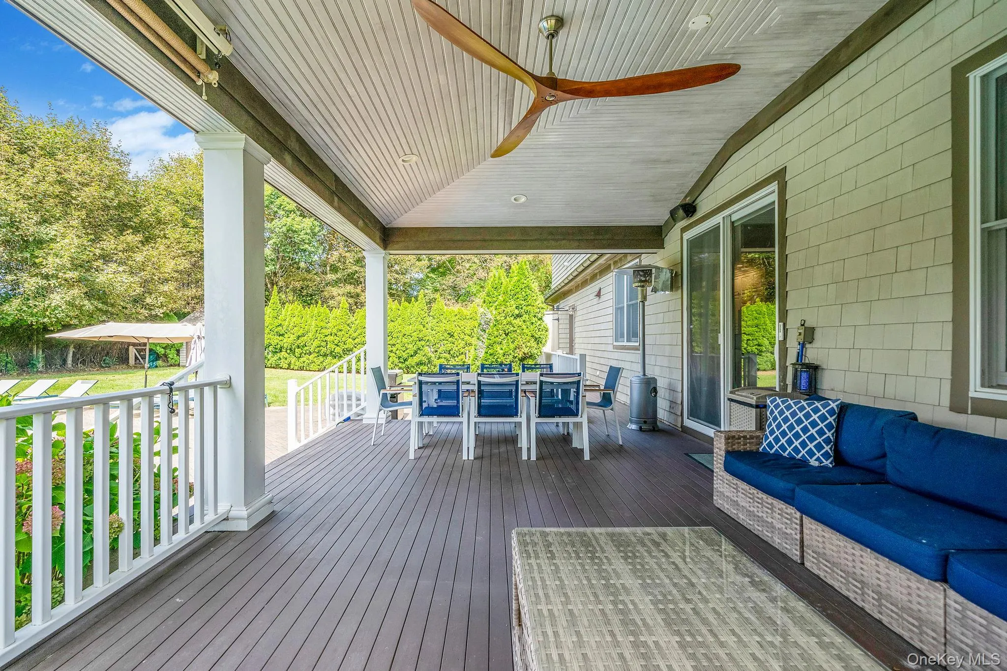 Wooden terrace featuring outdoor dining area, outdoor lounge area, and view of scattered trees Wooden terrace featuring outdoor dining area, outdoor lounge area, and view of scattered trees