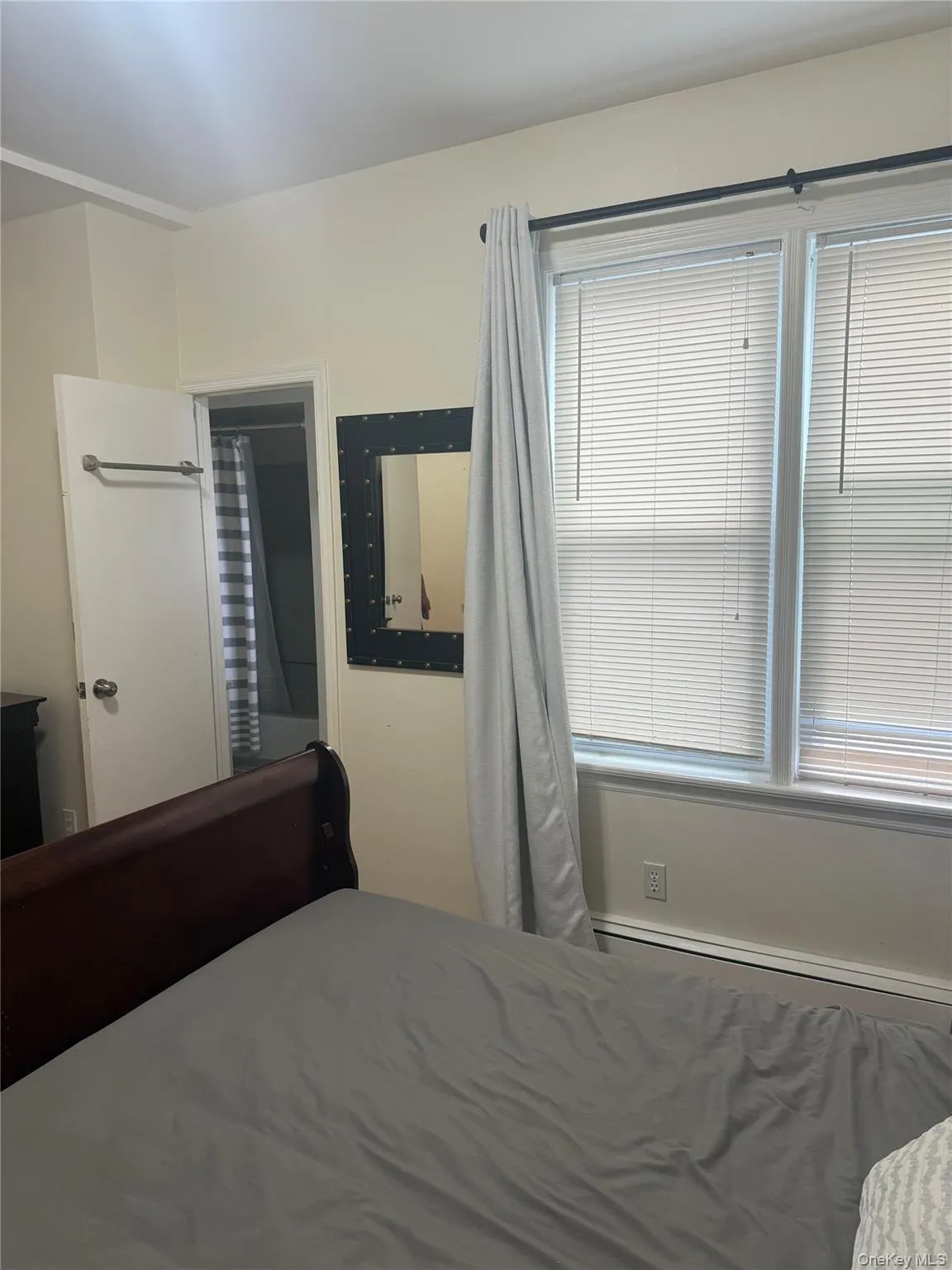 Bedroom featuring a baseboard heating unit Bedroom featuring a baseboard heating unit