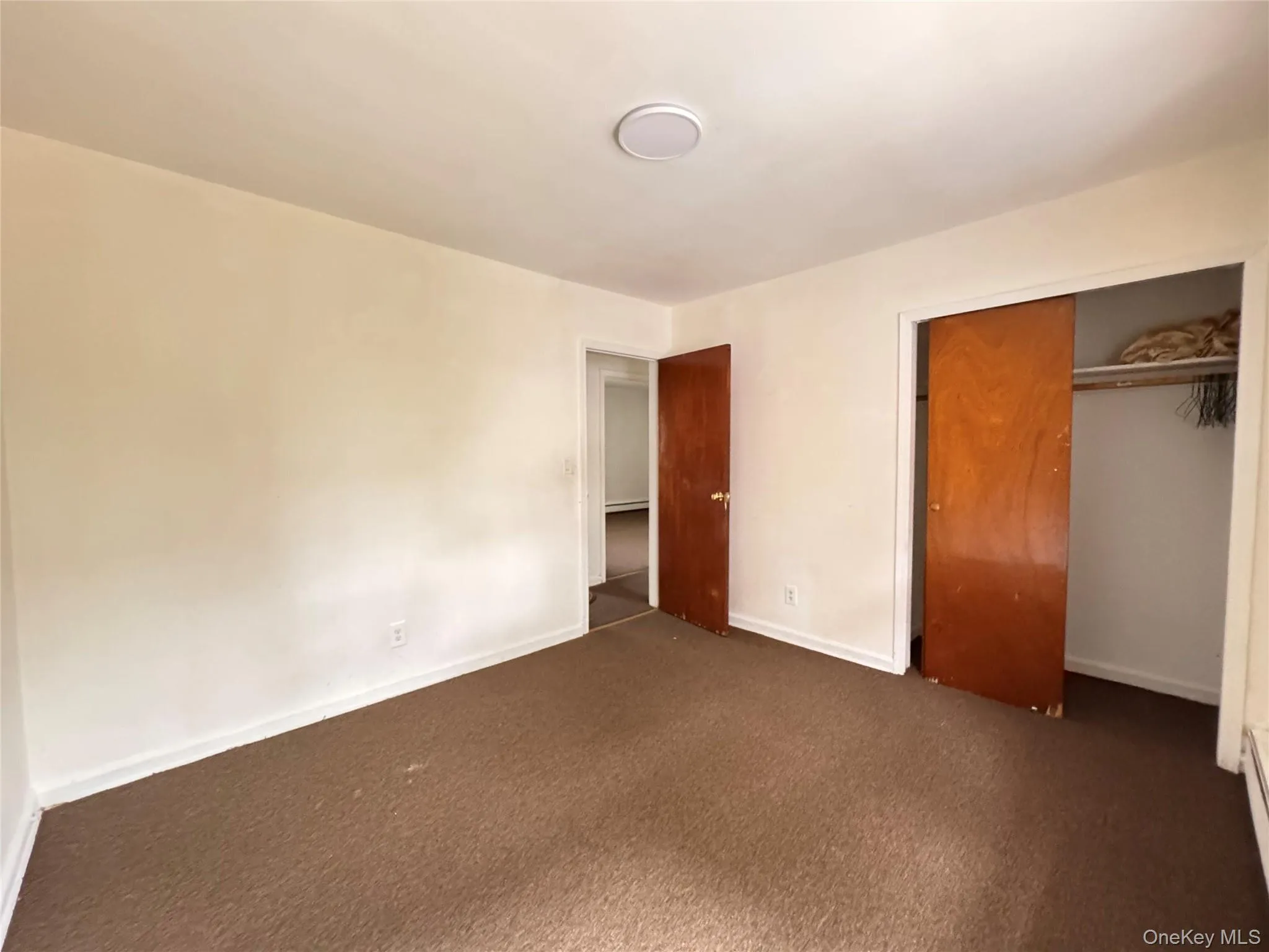 Unfurnished bedroom with carpet floors and a closet Unfurnished bedroom with carpet floors and a closet