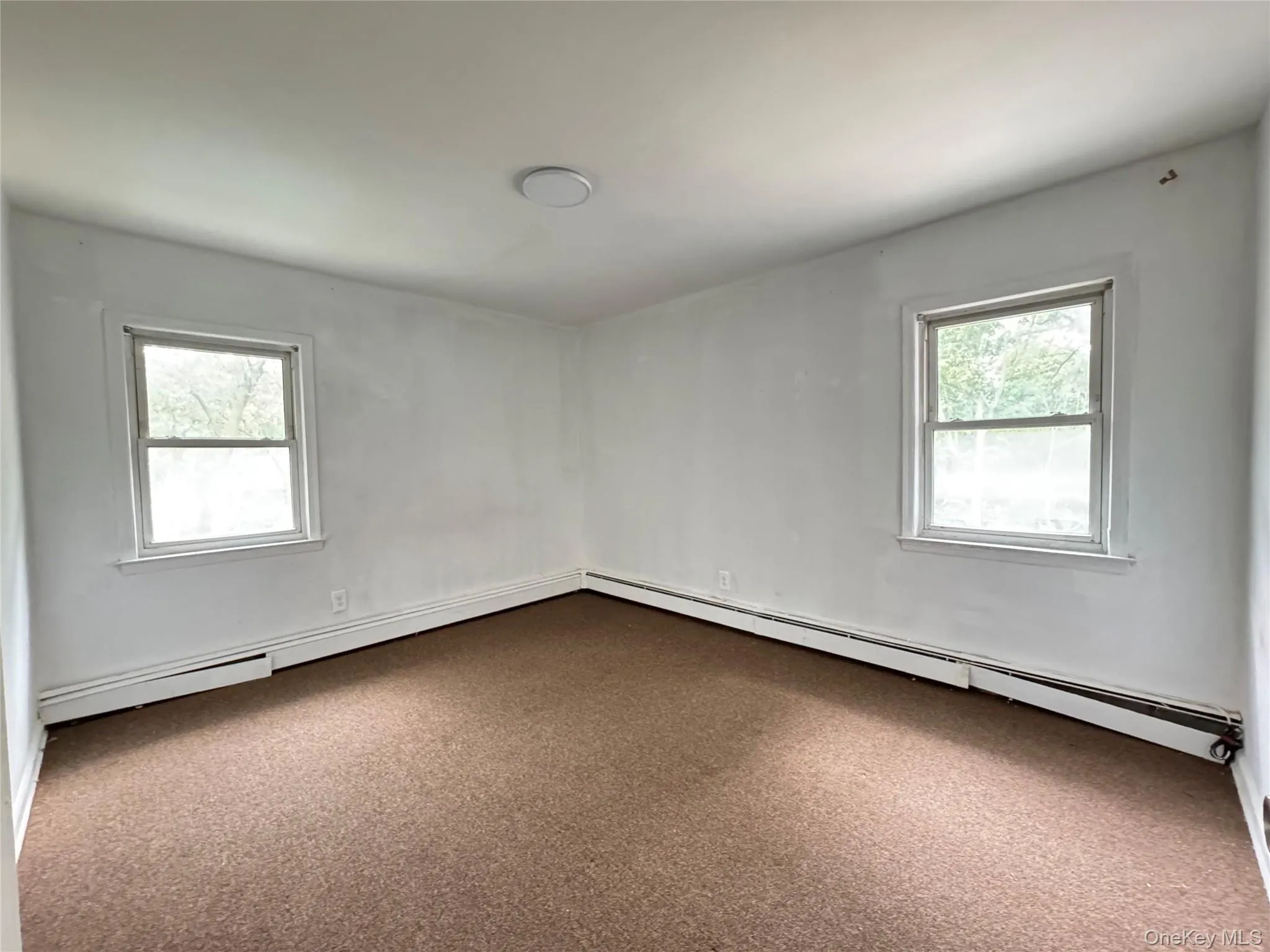 Spare room with a baseboard heating unit Spare room with a baseboard heating unit