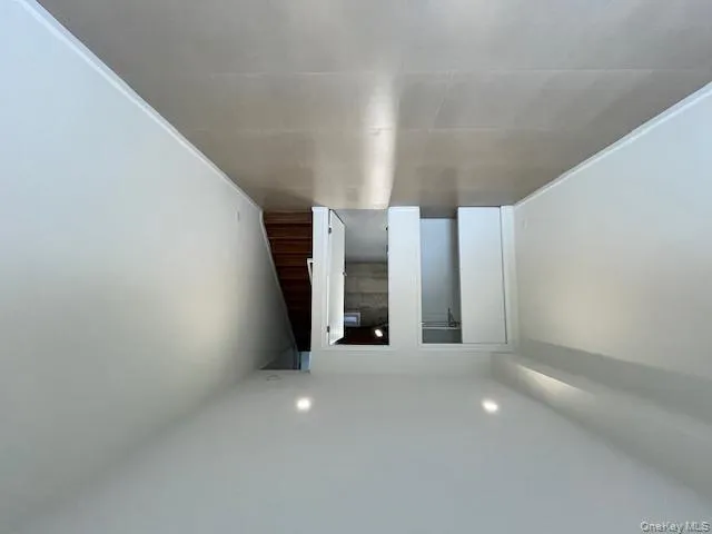 Finished basement featuring stairs and recessed lighting Finished basement featuring stairs and recessed lighting