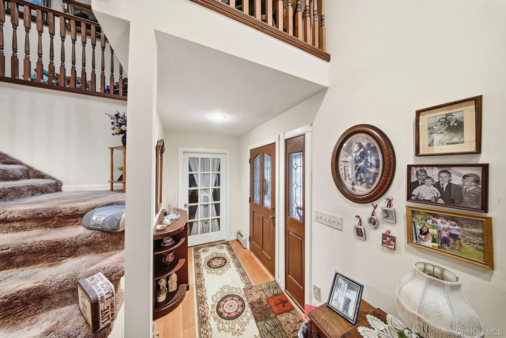 Entrance foyer with light wood-style floors and baseboard heating Entrance foyer with light wood-style floors and baseboard heating
