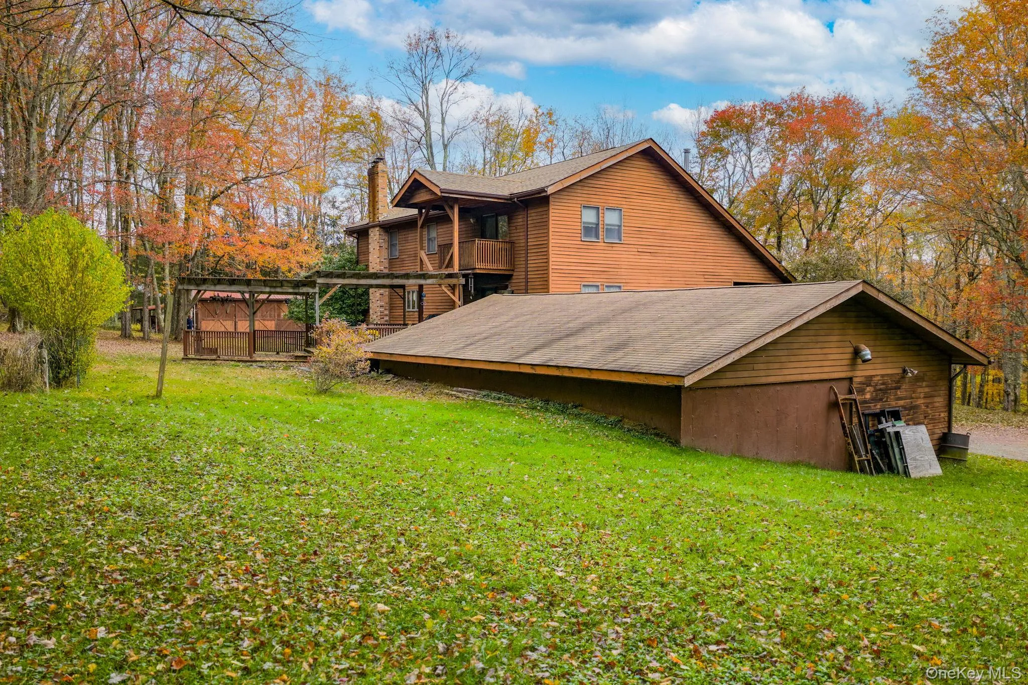 Rear view of property with a yard, a balcony, and a chimney Rear view of property with a yard, a balcony, and a chimney