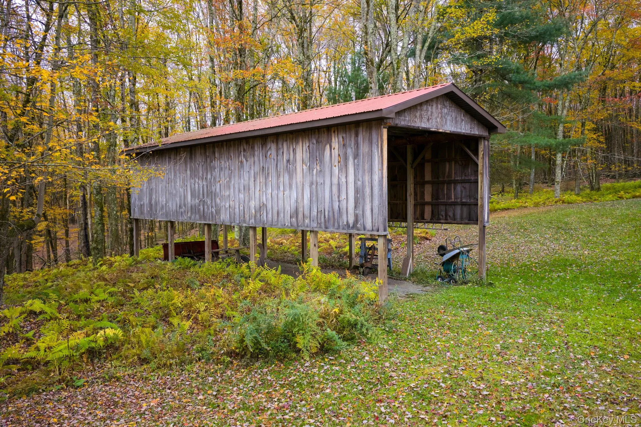 View of pole building with a forest view and a yard View of pole building with a forest view and a yard