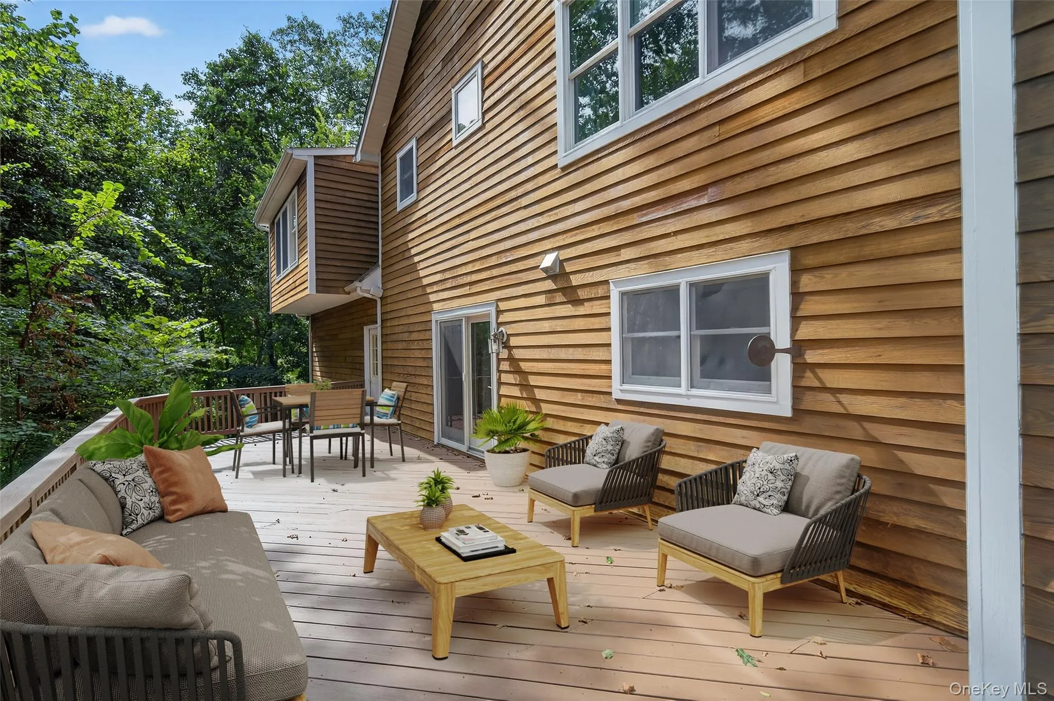 Wooden terrace featuring outdoor dining area and an outdoor hangout area Wooden terrace featuring outdoor dining area and an outdoor hangout area