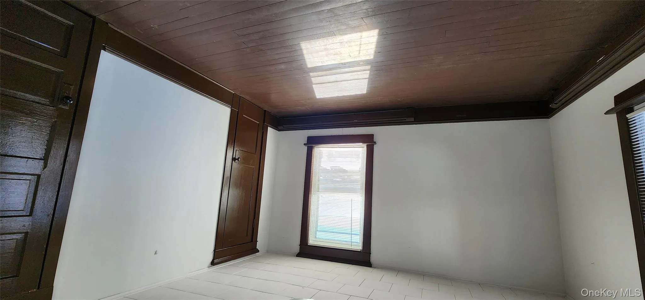 Spare room featuring dark wood finished floors and baseboards Spare room featuring dark wood finished floors and baseboards