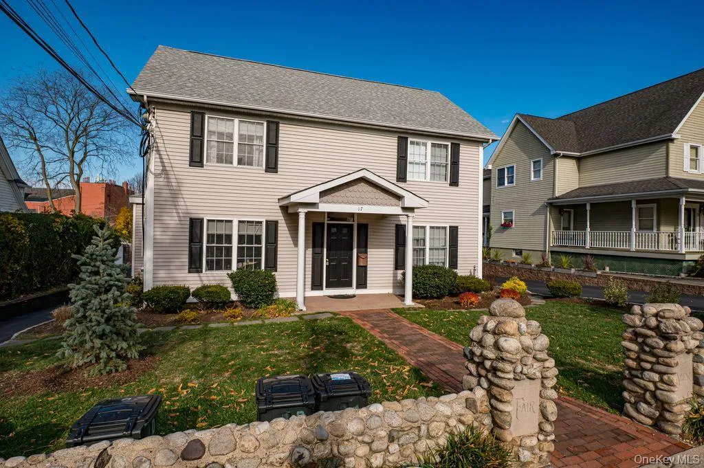 Colonial home featuring a front lawn Colonial home featuring a front lawn