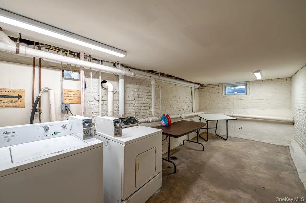 Washroom with concrete floors and washer and clothes dryer Washroom with concrete floors and washer and clothes dryer