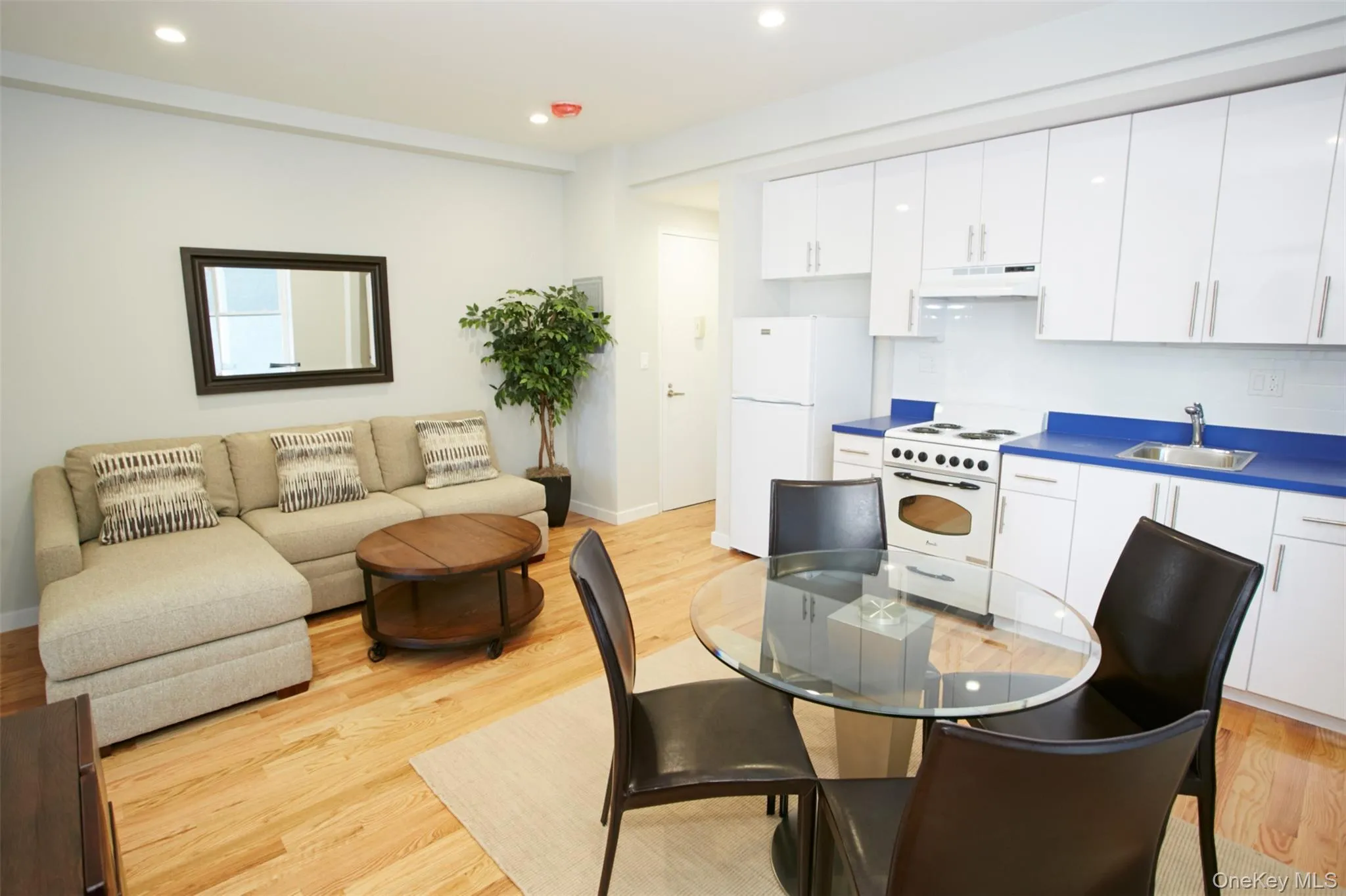 Dining room with light wood finished floors and recessed lighting Dining room with light wood finished floors and recessed lighting