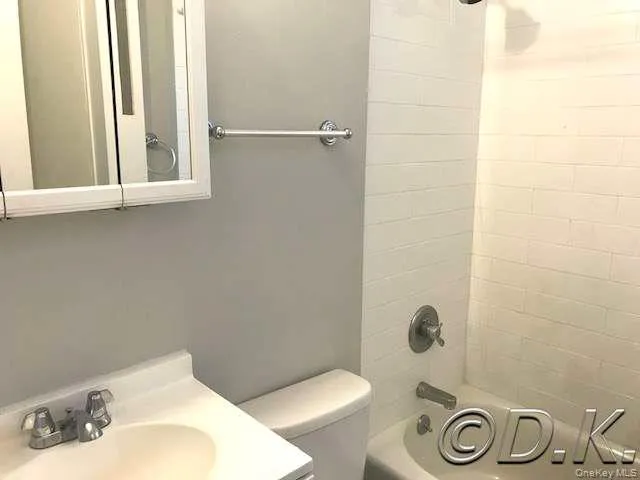 Bathroom featuring shower / washtub combination and vanity Bathroom featuring shower / washtub combination and vanity