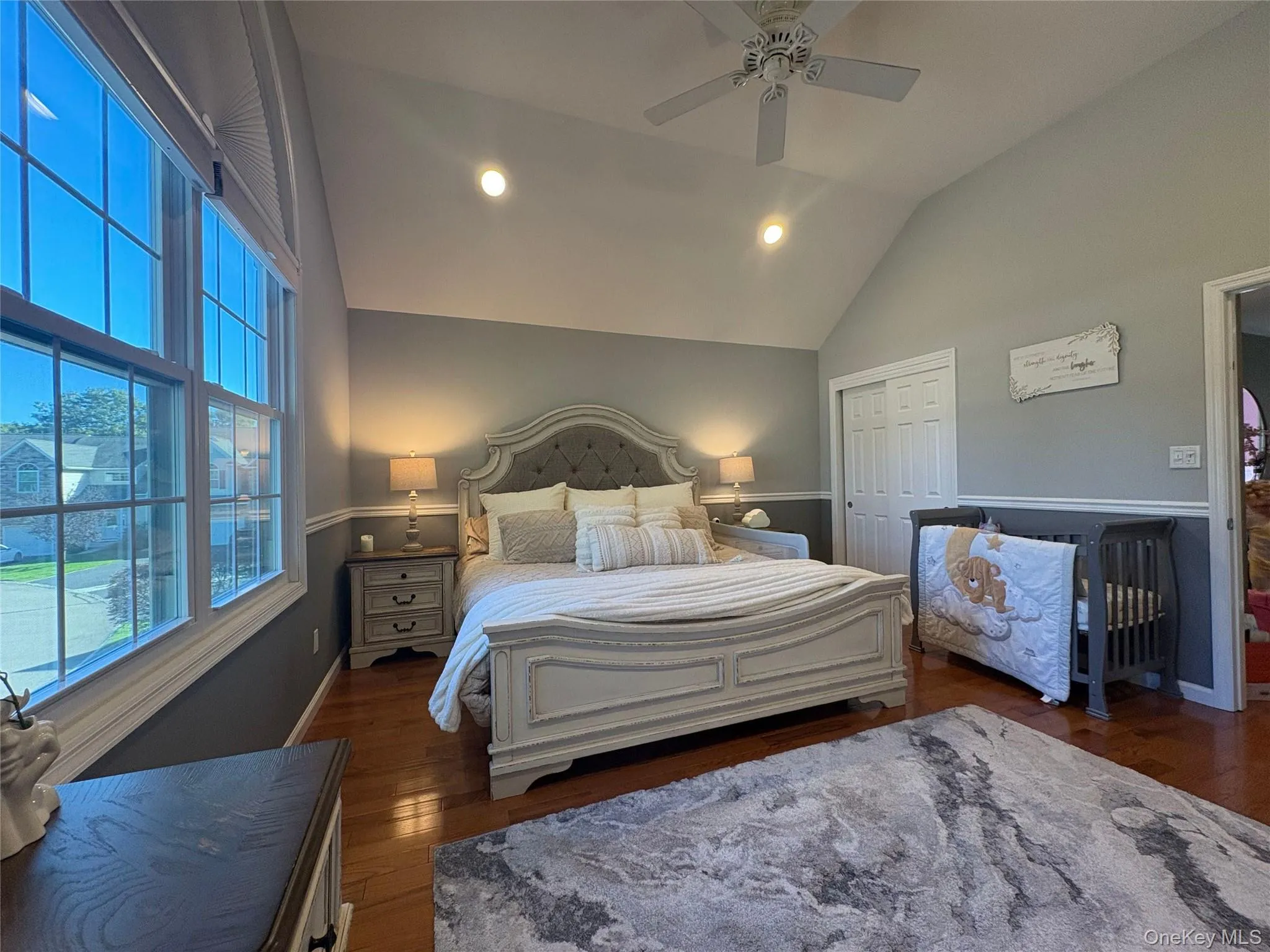 Bedroom featuring recessed lighting, dark wood finished floors, lofted ceiling, a closet, and a ceiling fan Bedroom featuring recessed lighting, dark wood finished floors, lofted ceiling, a closet, and a ceiling fan