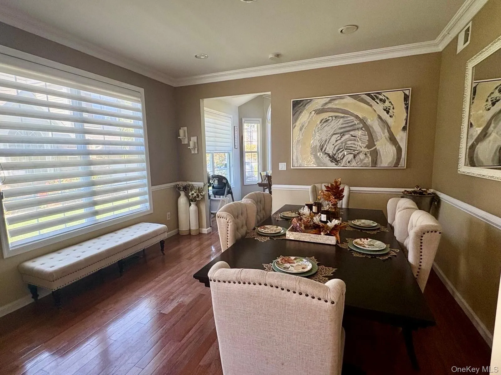 Dining space featuring ornamental molding and hardwood / wood-style floors Dining space featuring ornamental molding and hardwood / wood-style floors