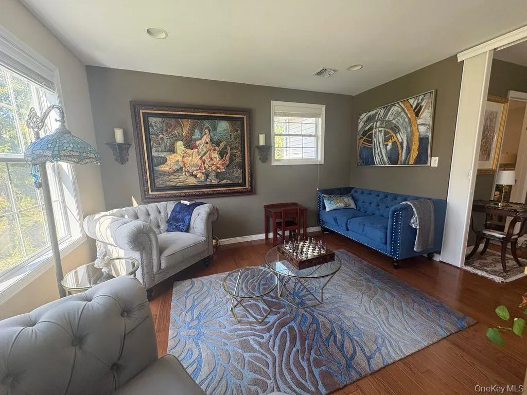 Living area with wood finished floors and recessed lighting Living area with wood finished floors and recessed lighting