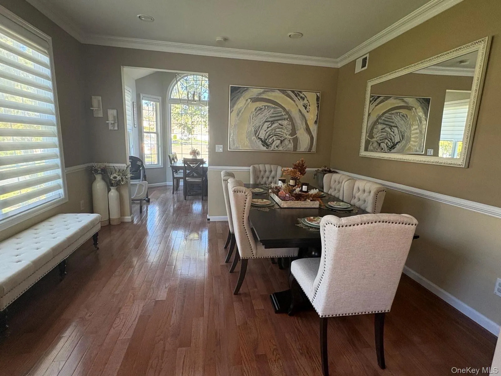 Dining room with ornamental molding and wood finished floors Dining room with ornamental molding and wood finished floors