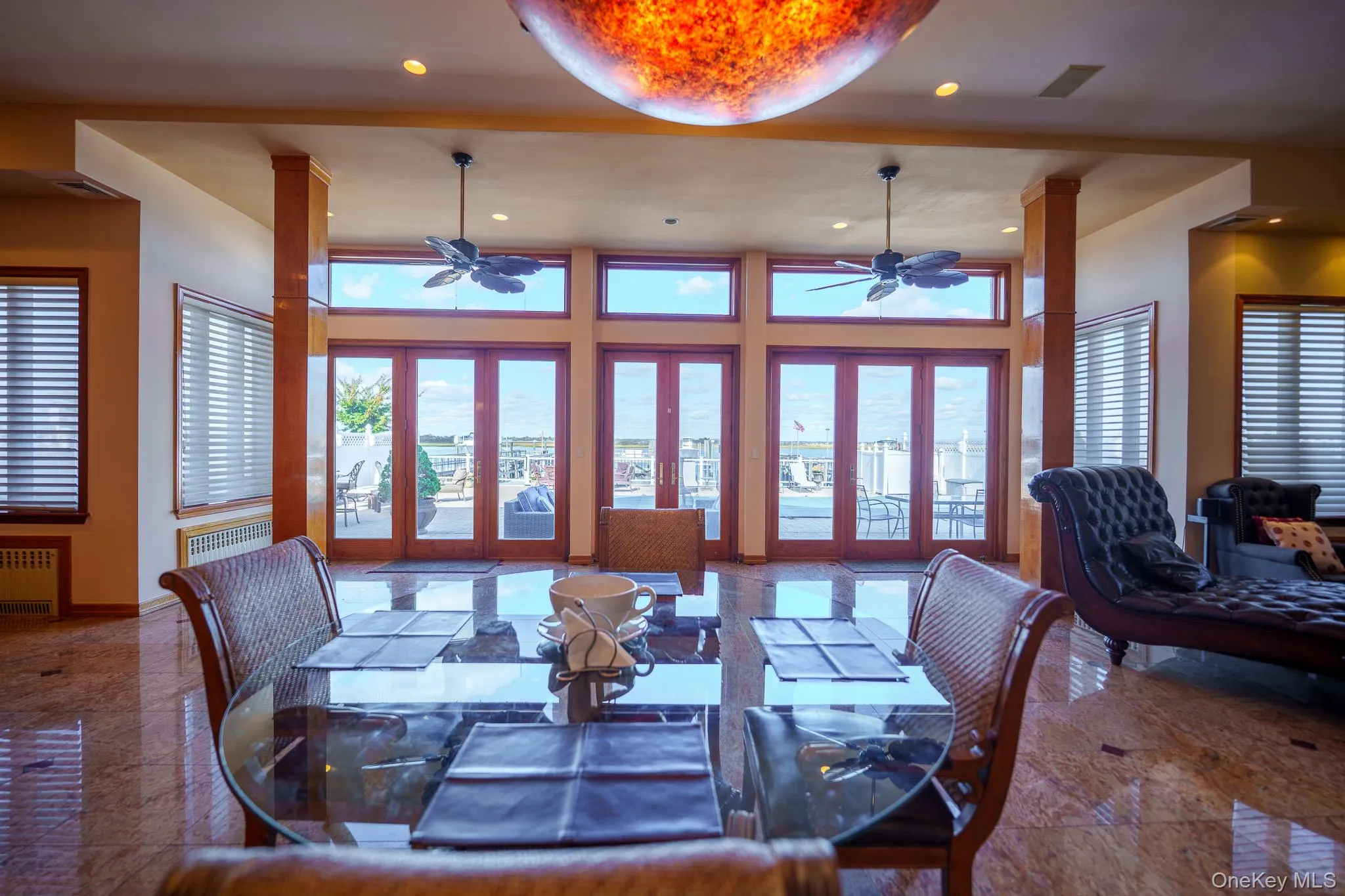 Dining space with a ceiling fan, recessed lighting, radiator, french doors, and a towering ceiling Dining space with a ceiling fan, recessed lighting, radiator, french doors, and a towering ceiling