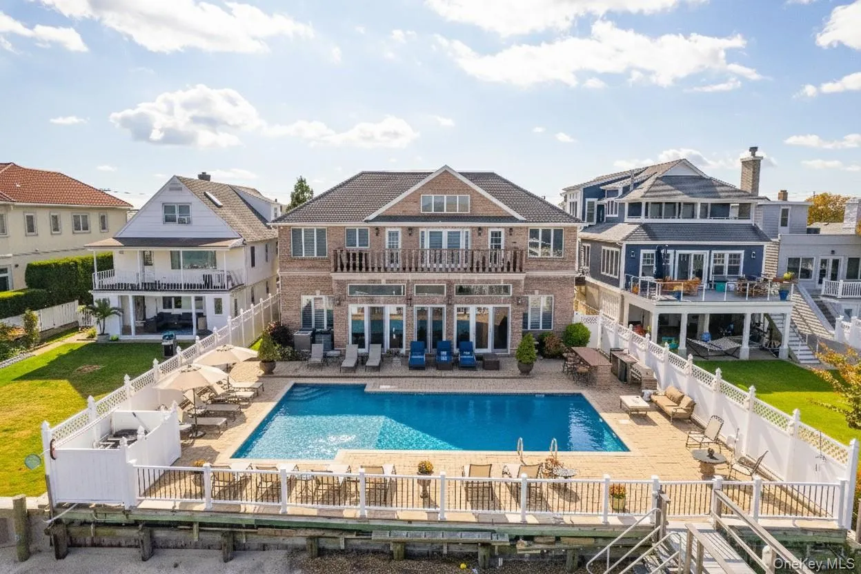 Back of property with a patio, a balcony, and a fenced backyard Back of property with a patio, a balcony, and a fenced backyard