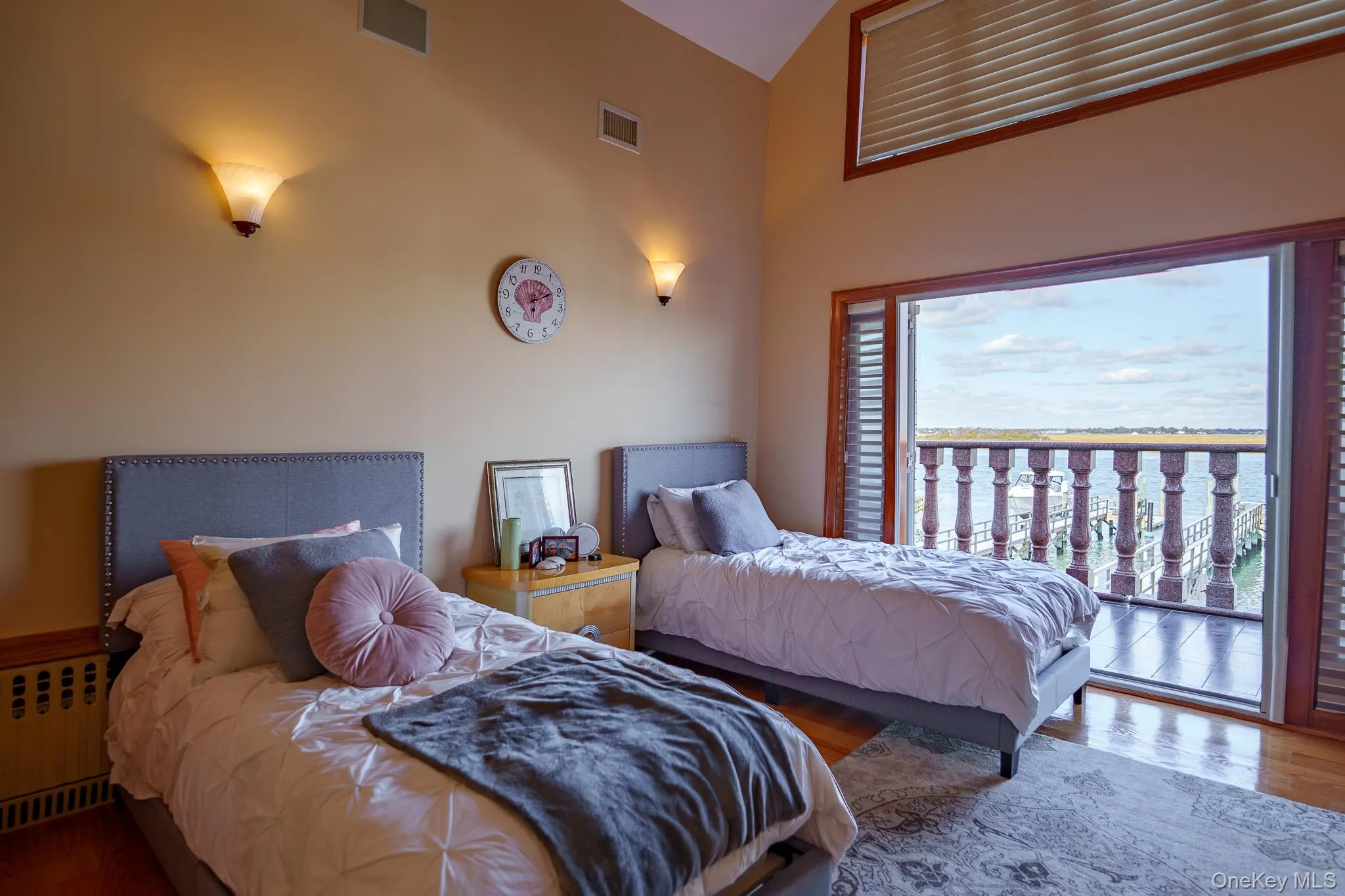 Bedroom featuring wood finished floors, radiator heating unit, and access to outside Bedroom featuring wood finished floors, radiator heating unit, and access to outside