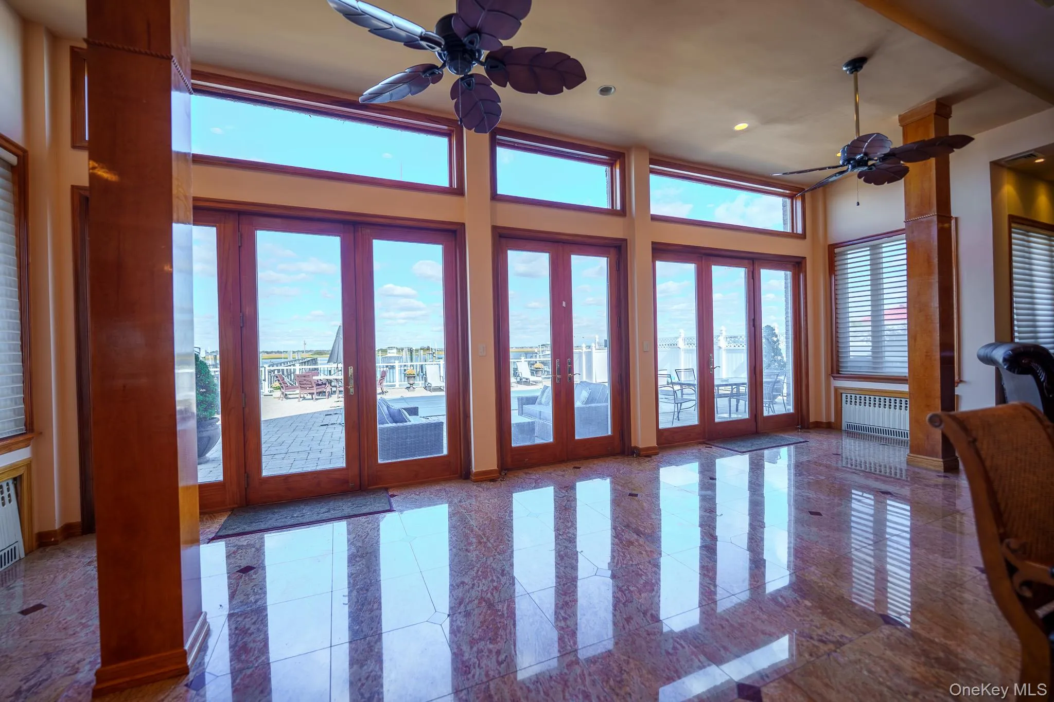 Living room with french doors, a ceiling fan, radiator, and recessed lighting Living room with french doors, a ceiling fan, radiator, and recessed lighting