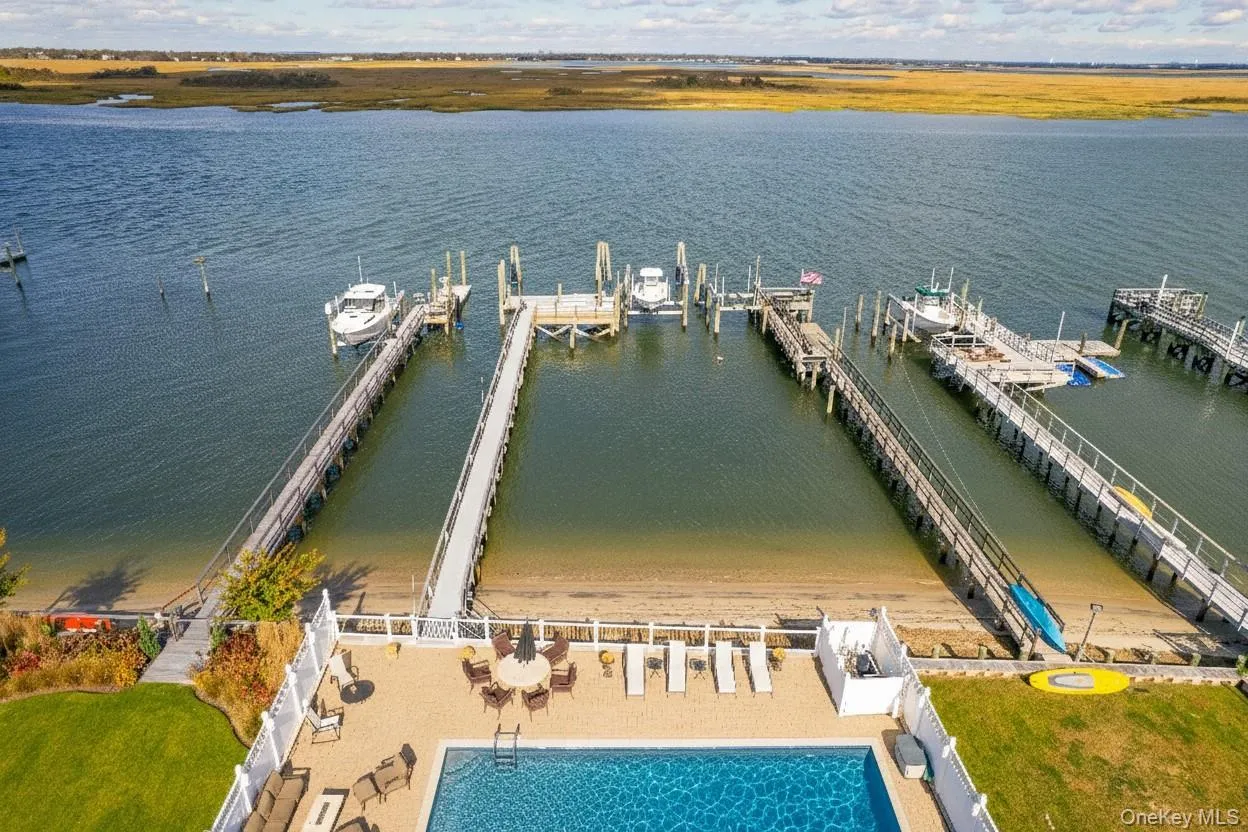 Aerial view of a pool area and a large body of water Aerial view of a pool area and a large body of water