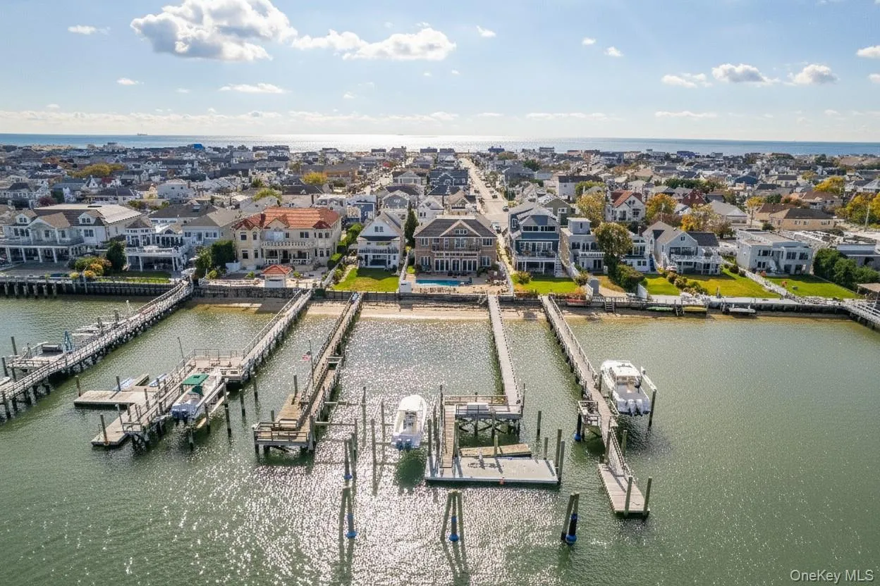 Aerial view of residential area featuring a large body of water Aerial view of residential area featuring a large body of water