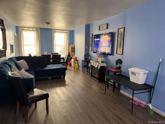 Living room featuring wood finished floors and baseboards Living room featuring wood finished floors and baseboards