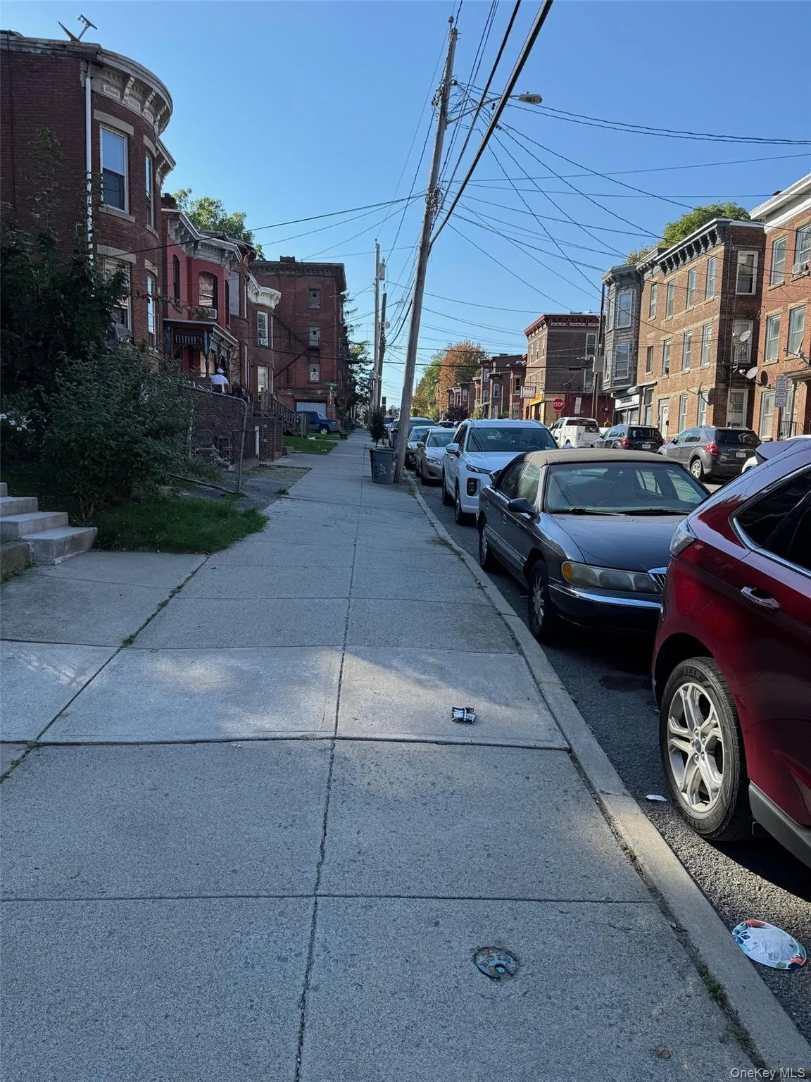 View of asphalt road featuring street lighting, sidewalks, and a residential view View of asphalt road featuring street lighting, sidewalks, and a residential view