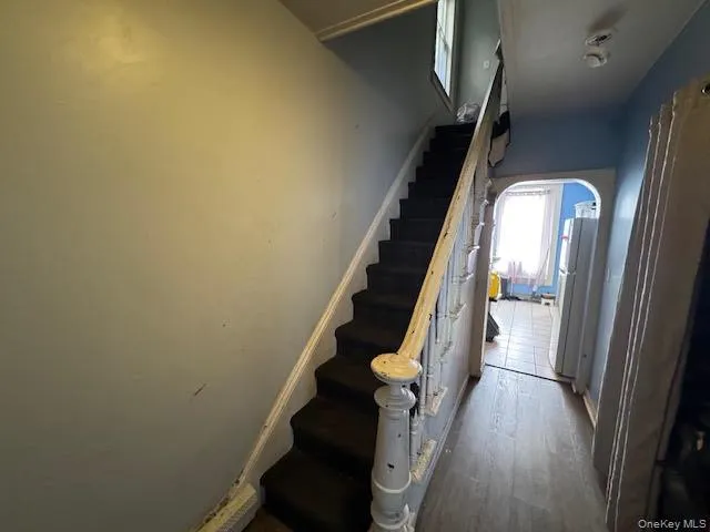 Staircase with arched walkways and wood finished floors Staircase with arched walkways and wood finished floors