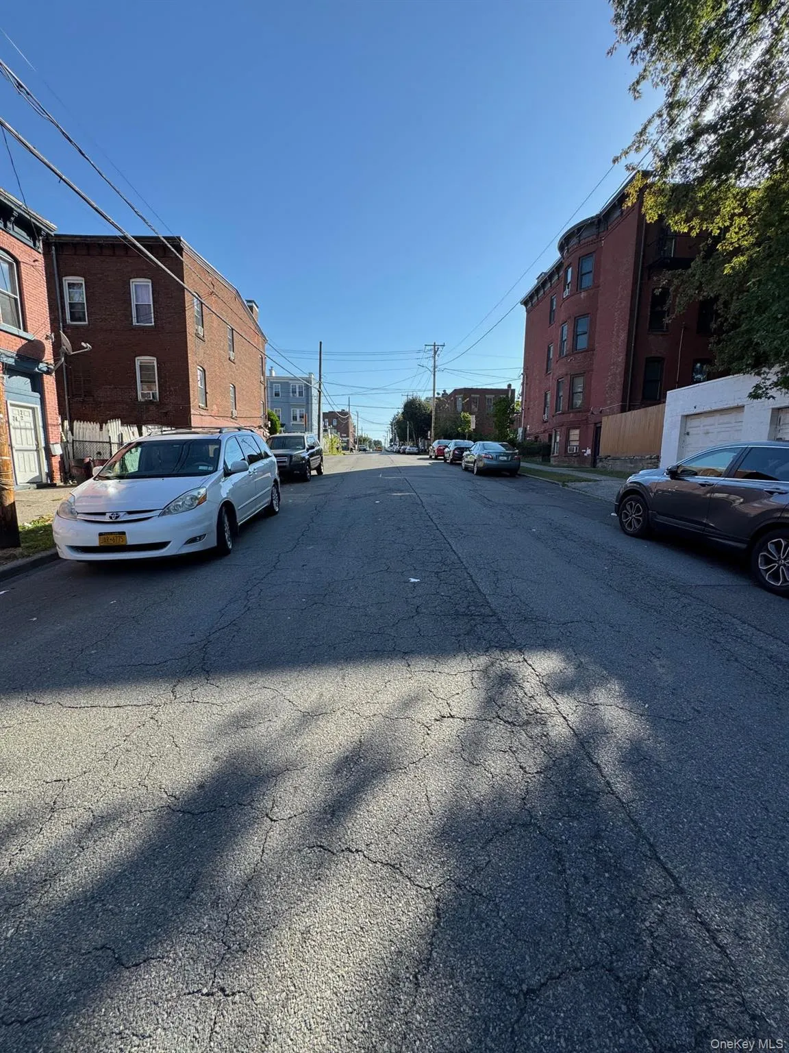 View of asphalt road with curbs and sidewalks View of asphalt road with curbs and sidewalks