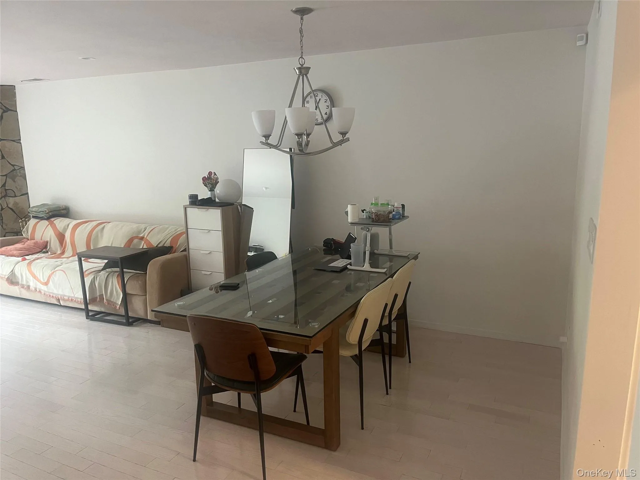 Dining space with light wood finished floors and a chandelier Dining space with light wood finished floors and a chandelier