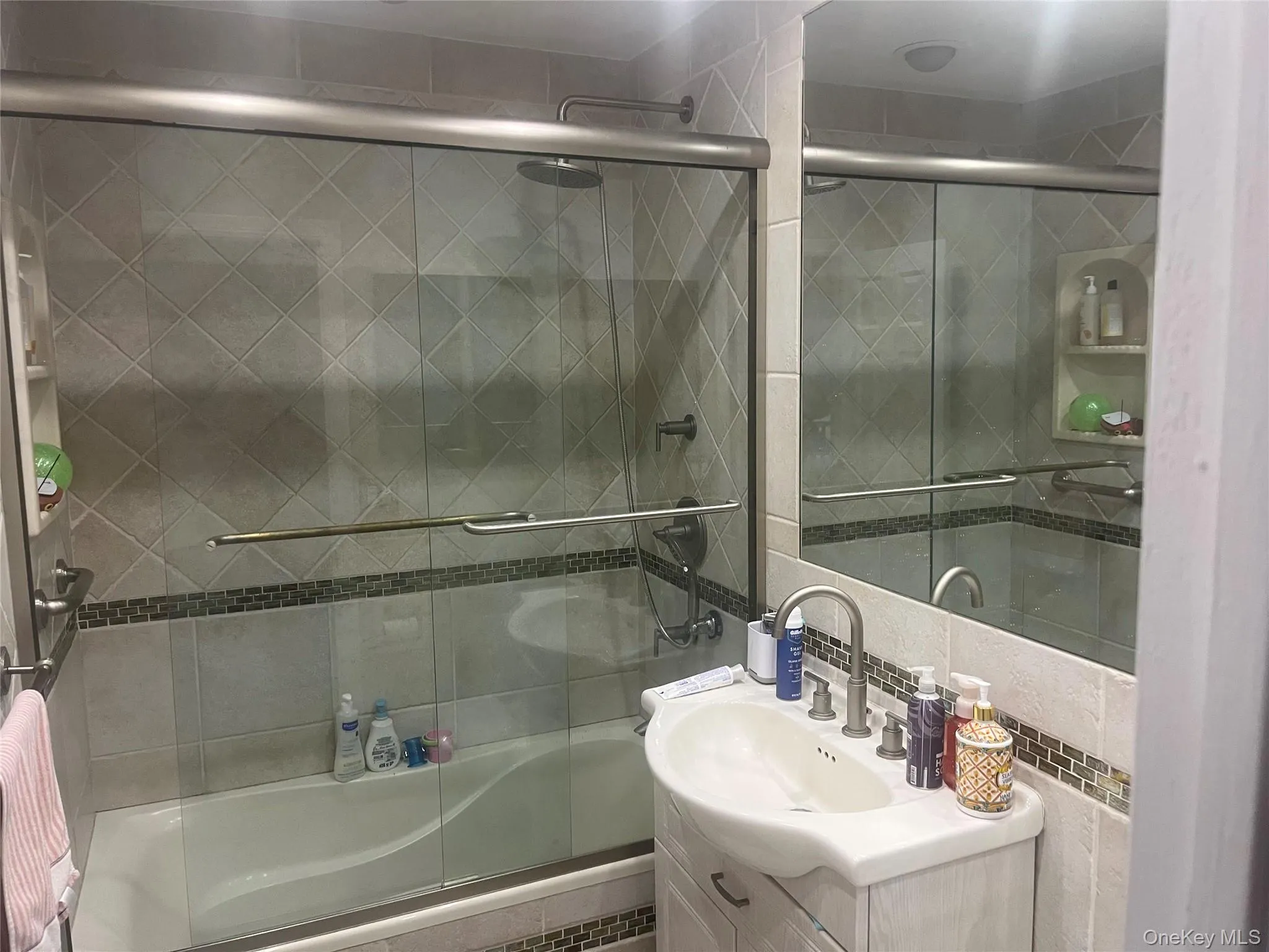 Full bath featuring tiled shower / bath combo and vanity Full bath featuring tiled shower / bath combo and vanity