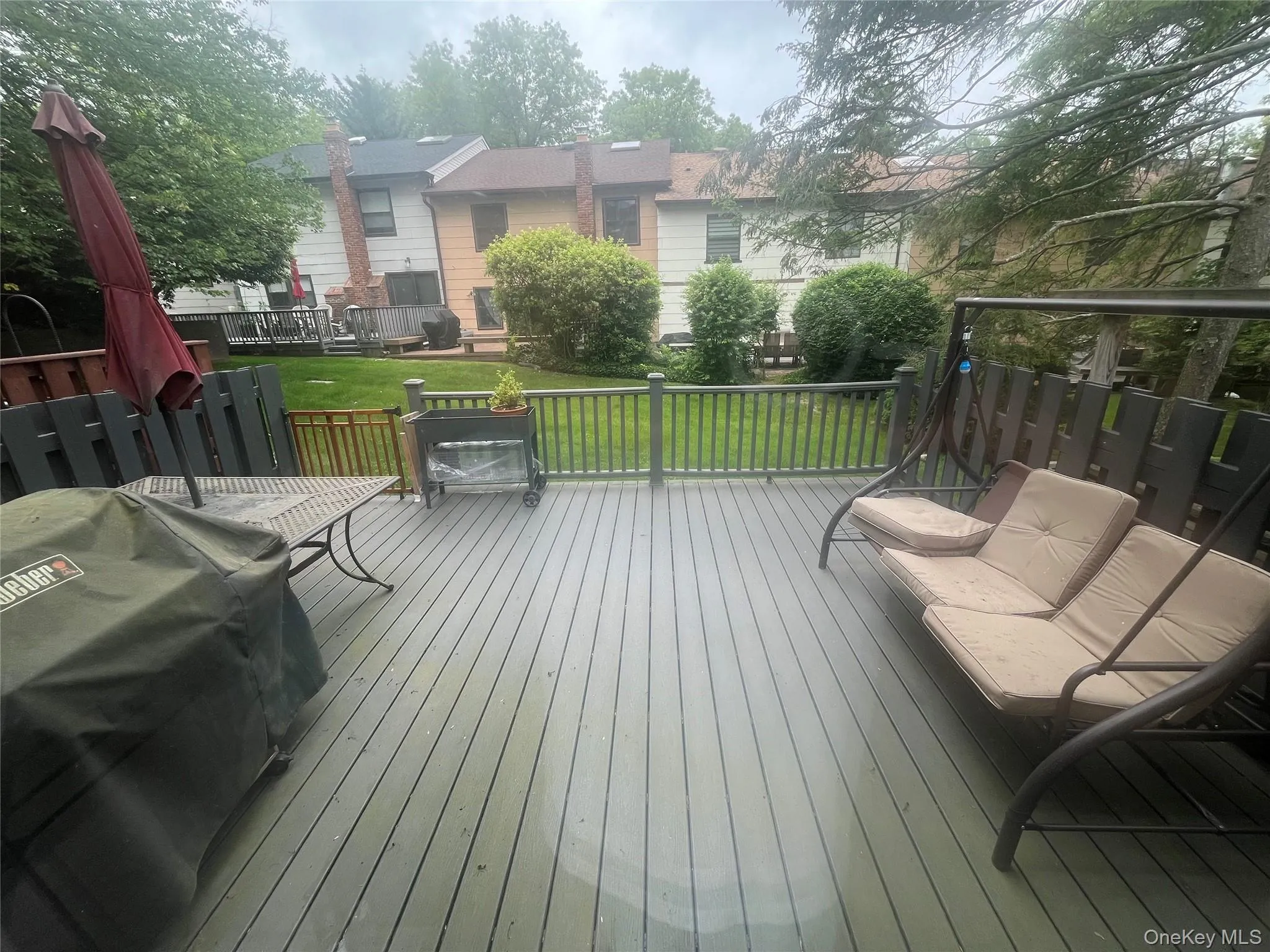 Deck featuring grilling area and a yard Deck featuring grilling area and a yard