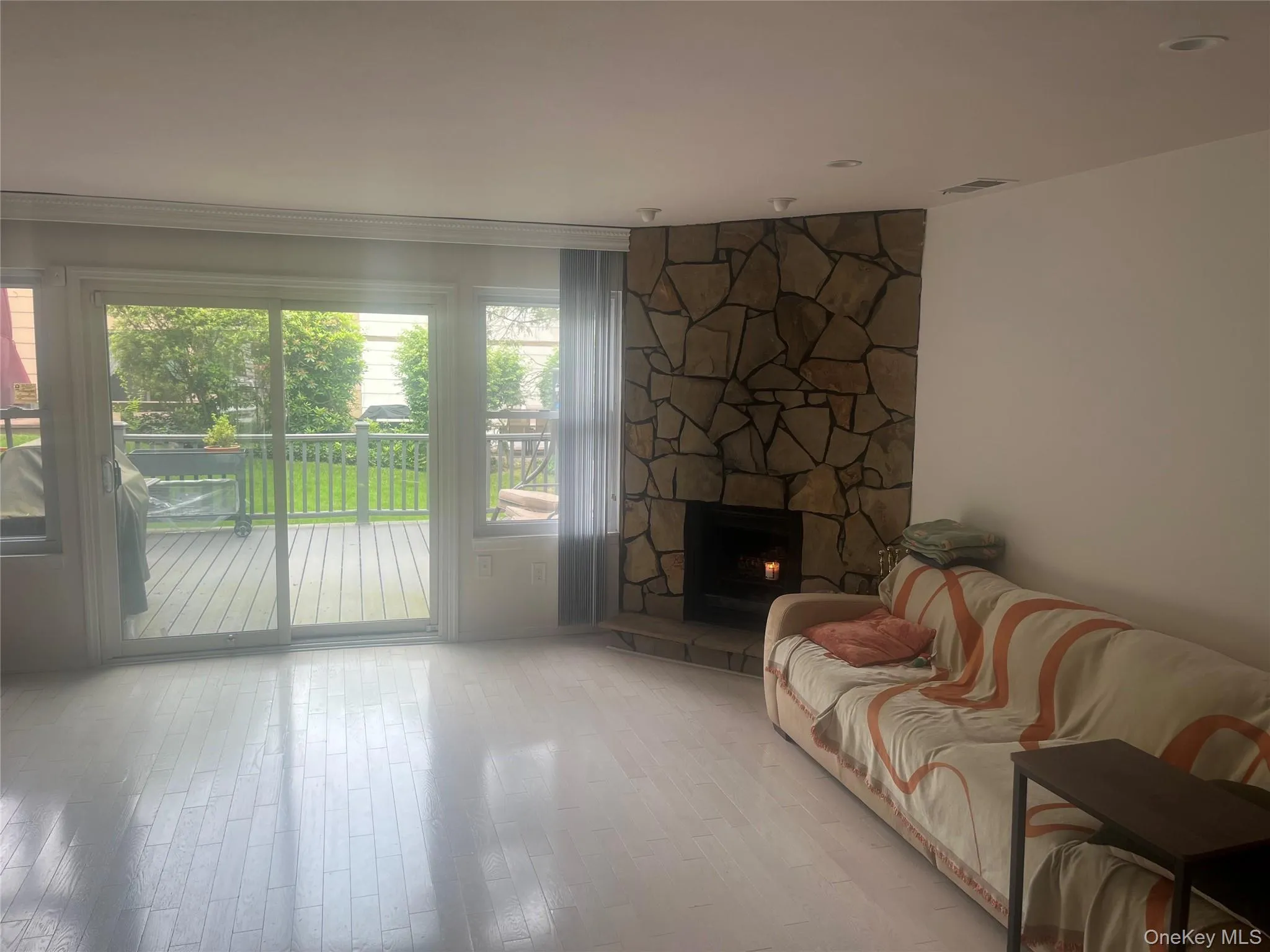 Living room featuring a fireplace and wood finished floors Living room featuring a fireplace and wood finished floors