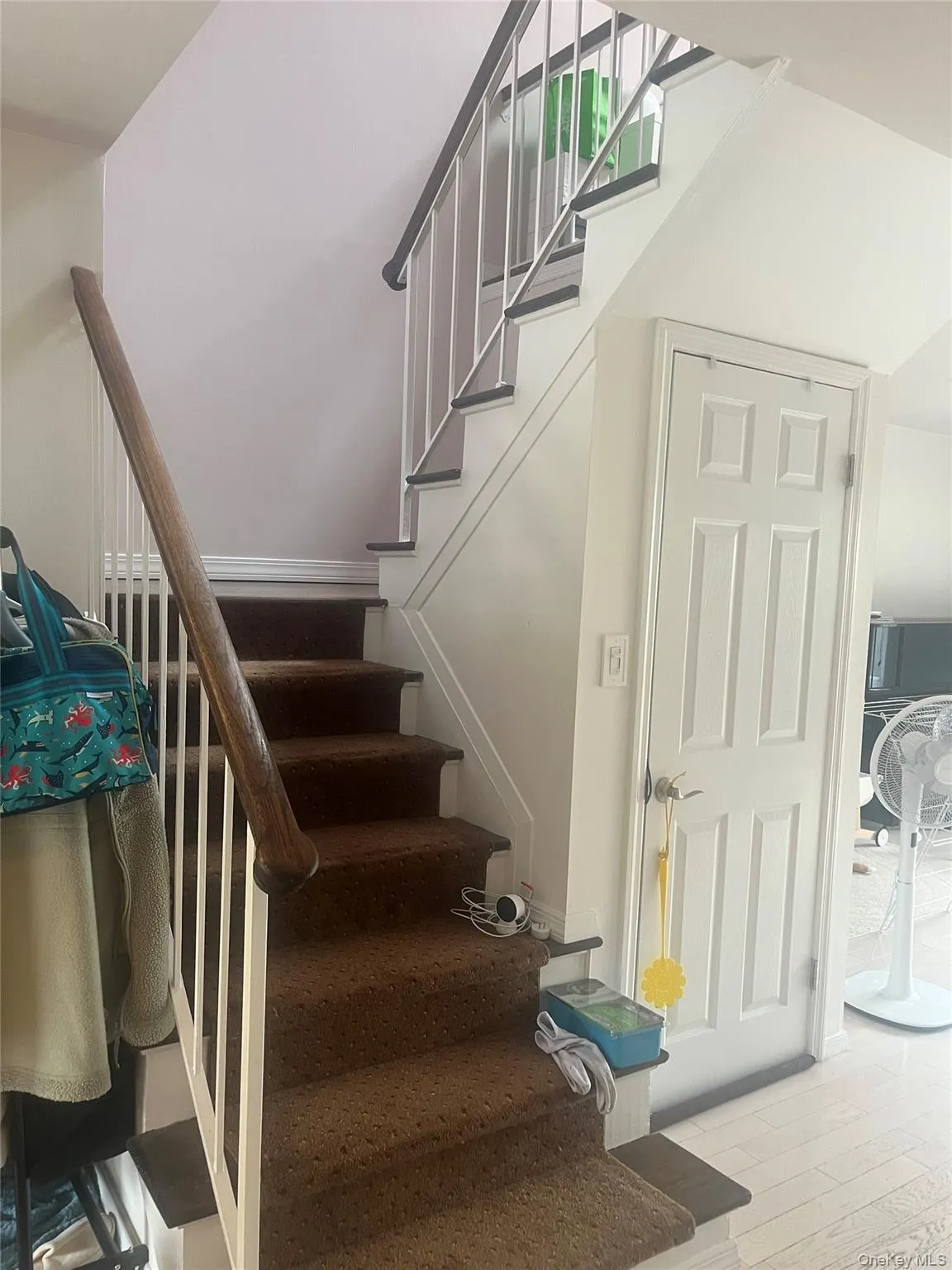 Stairs featuring wood finished floors Stairs featuring wood finished floors