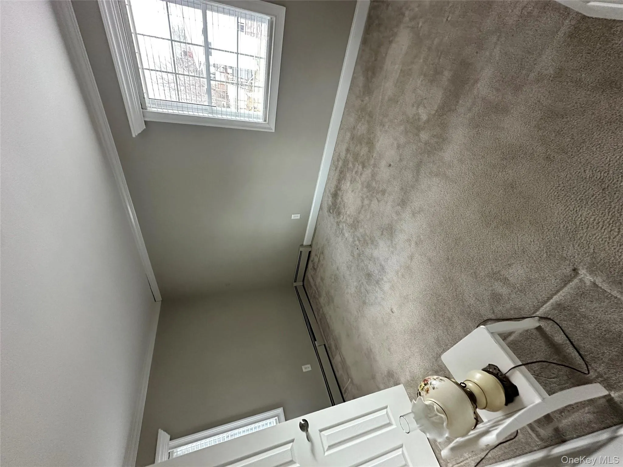 Carpeted empty room with crown molding and baseboard heating Carpeted empty room with crown molding and baseboard heating