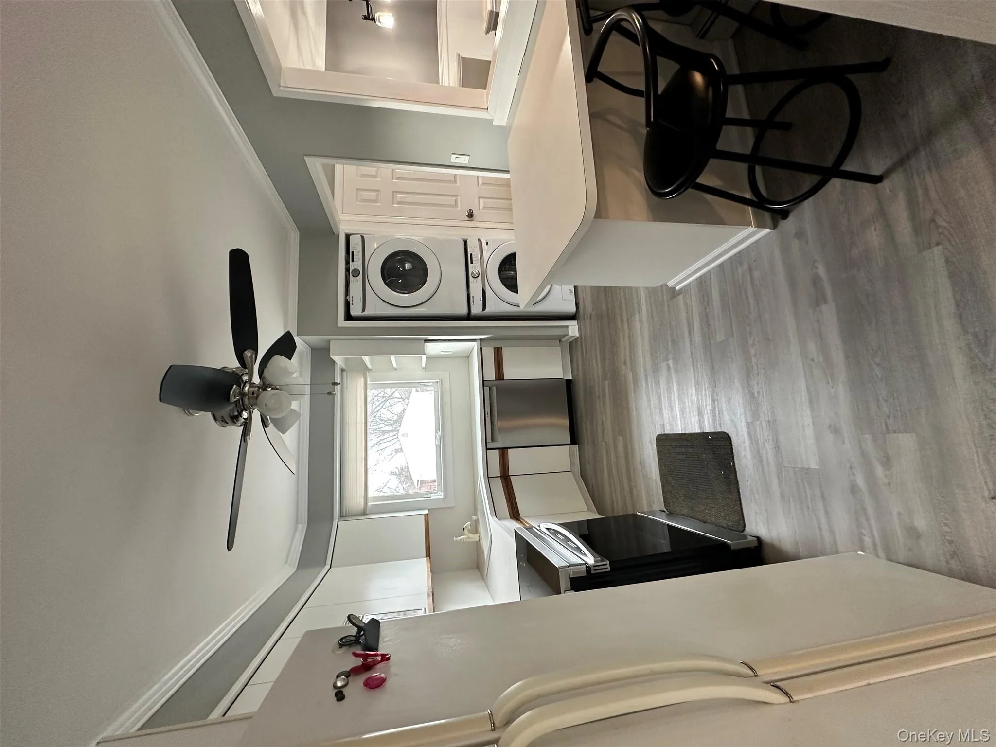 Kitchen featuring white cabinets, light countertops, crown molding, fridge, and range Kitchen featuring white cabinets, light countertops, crown molding, fridge, and range