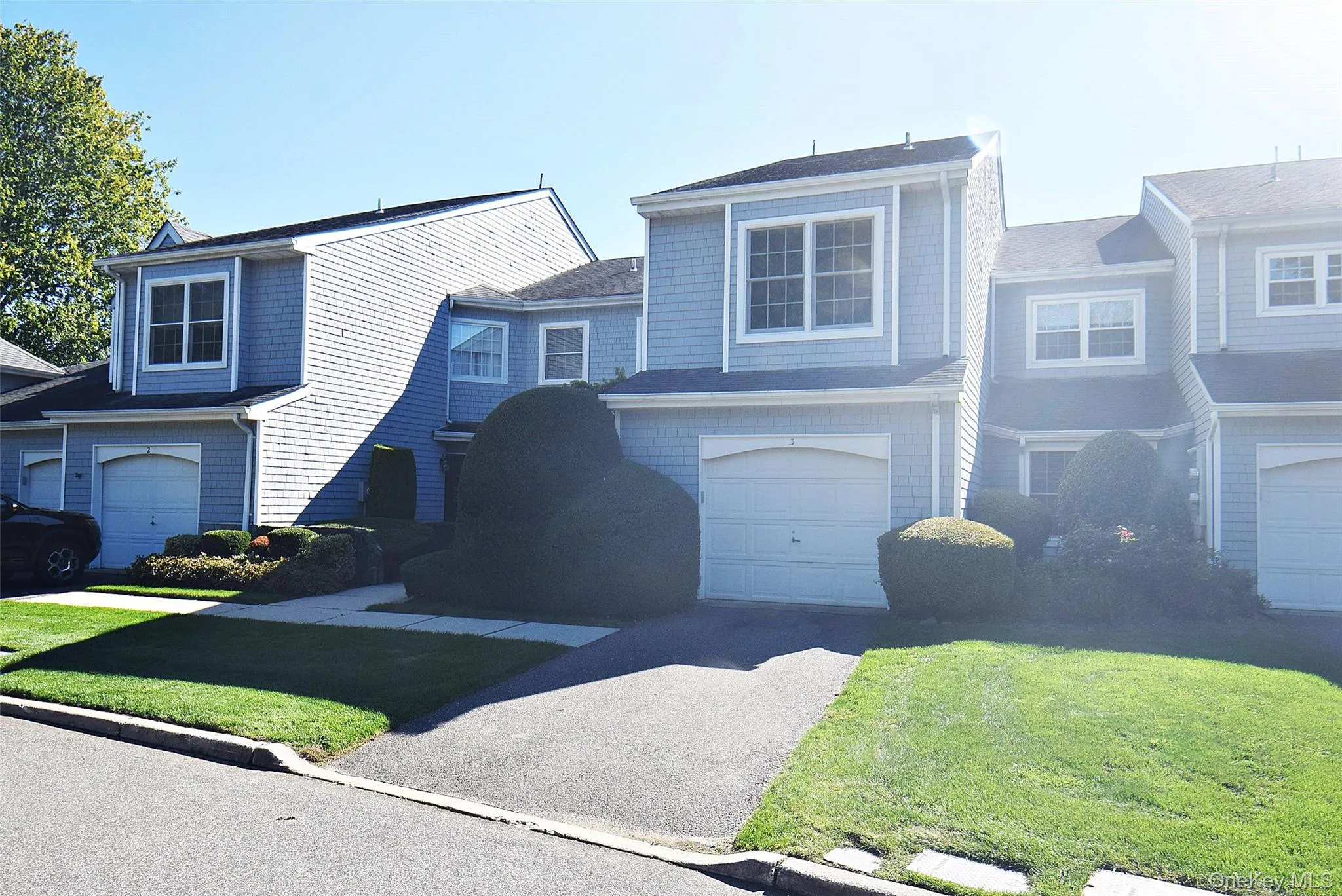 View of front of house with a front lawn and driveway View of front of house with a front lawn and driveway