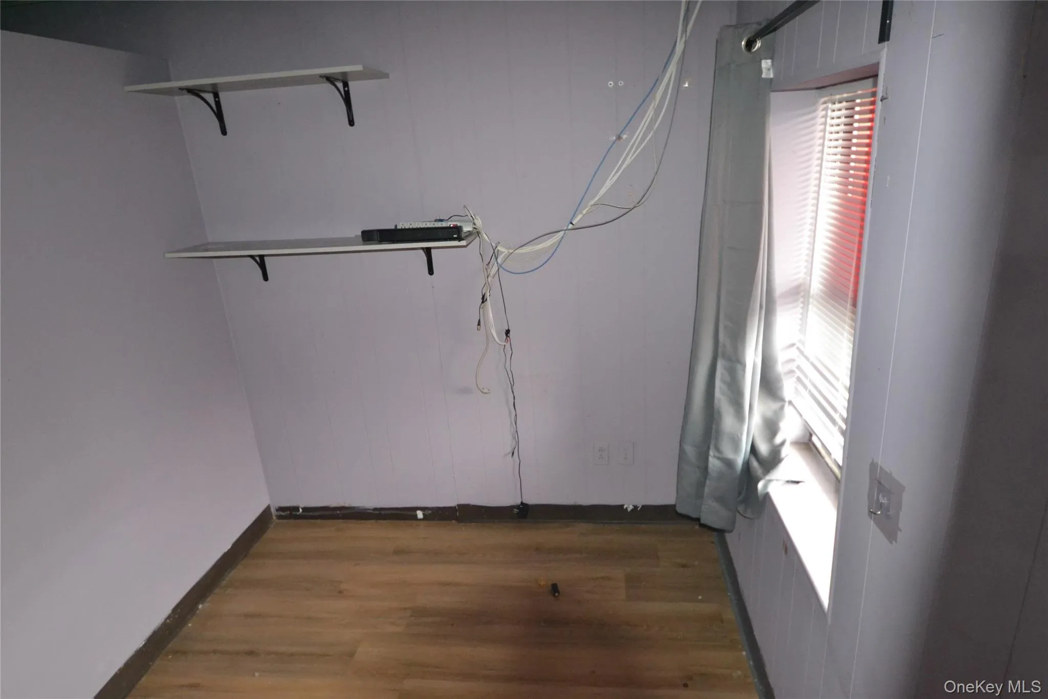 Washroom with dark wood-style floors and baseboards Washroom with dark wood-style floors and baseboards