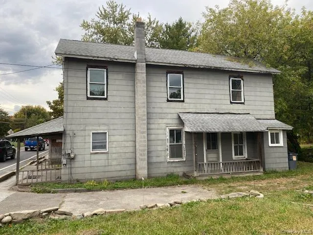 View of front of property featuring roof with shingles, a porch, and a chimney View of front of property featuring roof with shingles, a porch, and a chimney