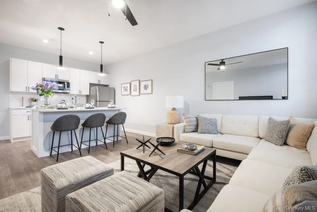 Living room featuring ceiling fan, light wood finished floors, and recessed lighting Living room featuring ceiling fan, light wood finished floors, and recessed lighting