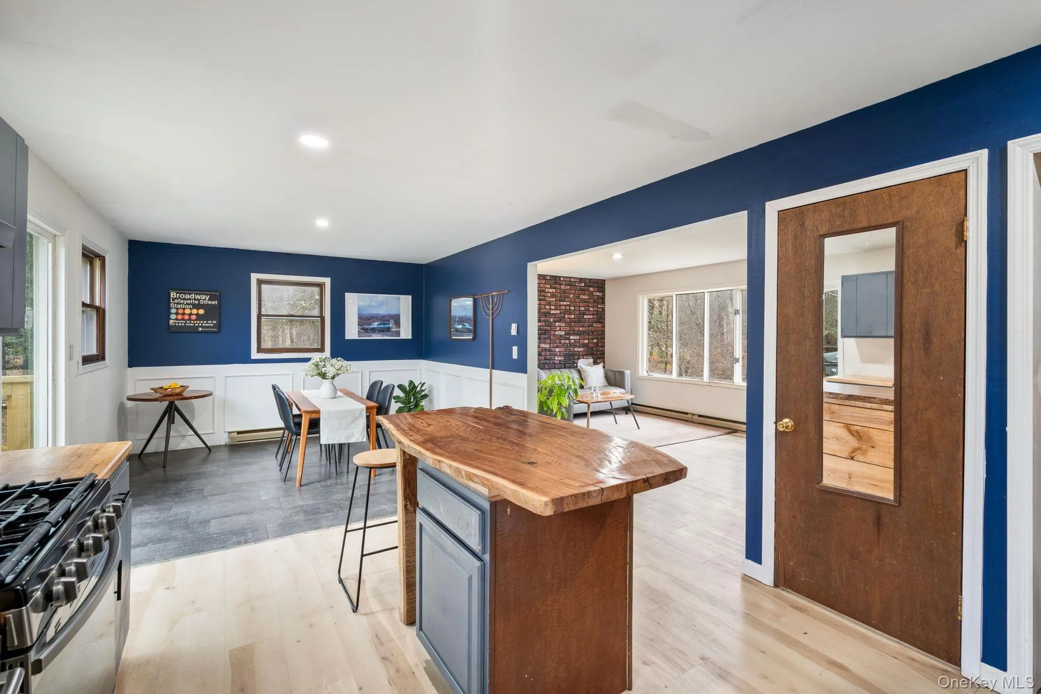 Kitchen featuring butcher block counters, a kitchen breakfast bar, gas stove, a kitchen island, and light wood-style flooring Kitchen featuring butcher block counters, a kitchen breakfast bar, gas stove, a kitchen island, and light wood-style flooring