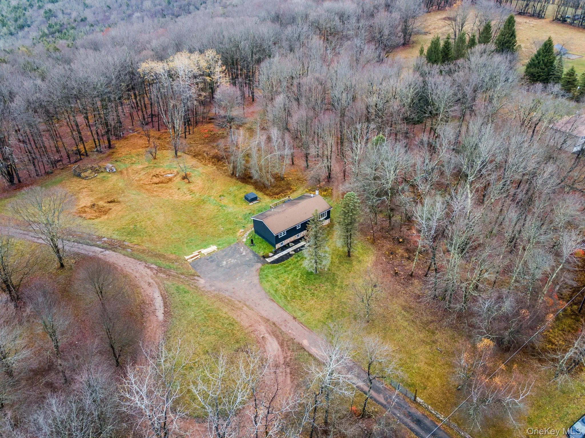View from above of property with a heavily wooded area View from above of property with a heavily wooded area