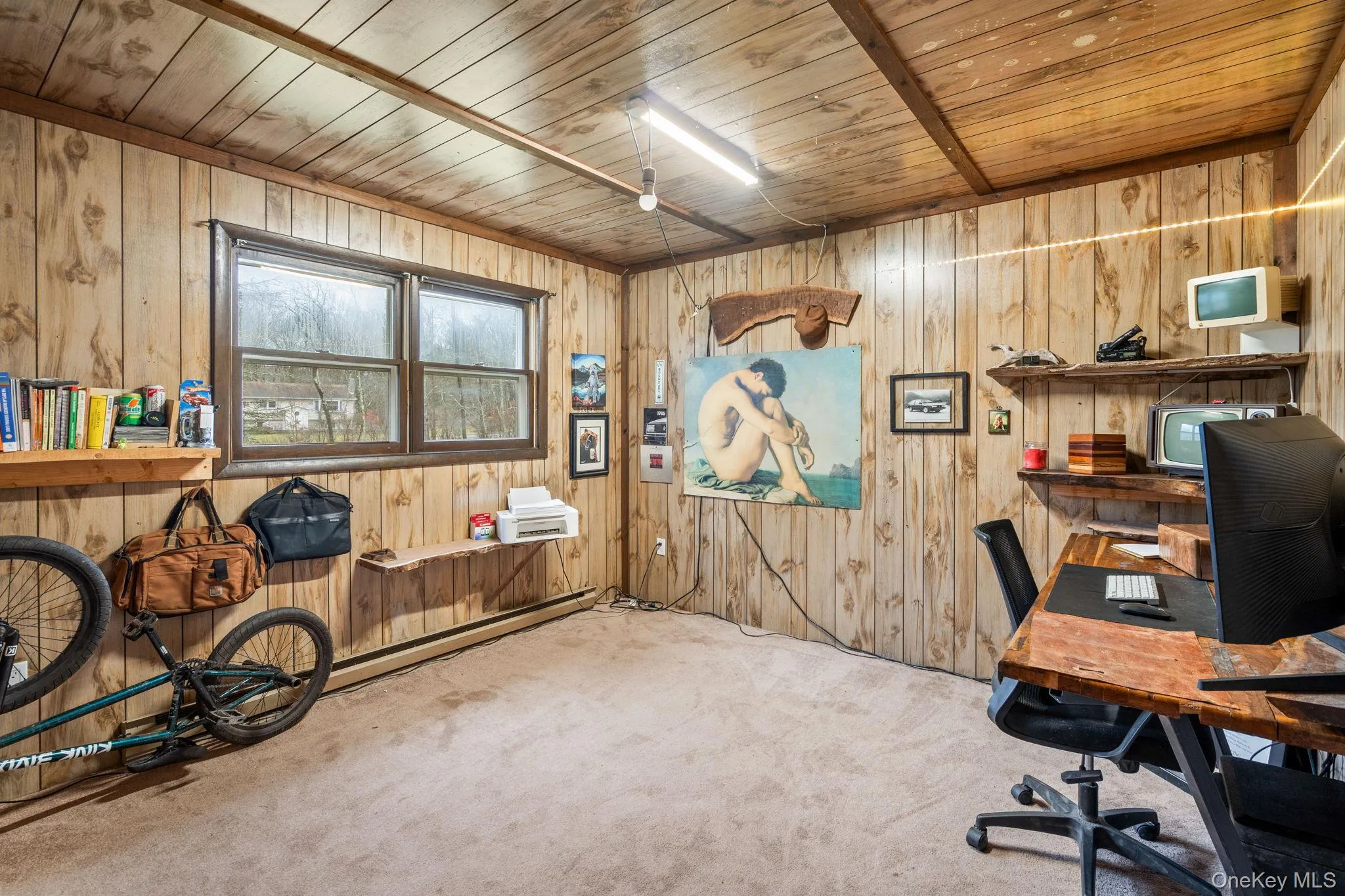 Carpeted office space featuring wooden ceiling, wooden walls, and baseboard heating Carpeted office space featuring wooden ceiling, wooden walls, and baseboard heating