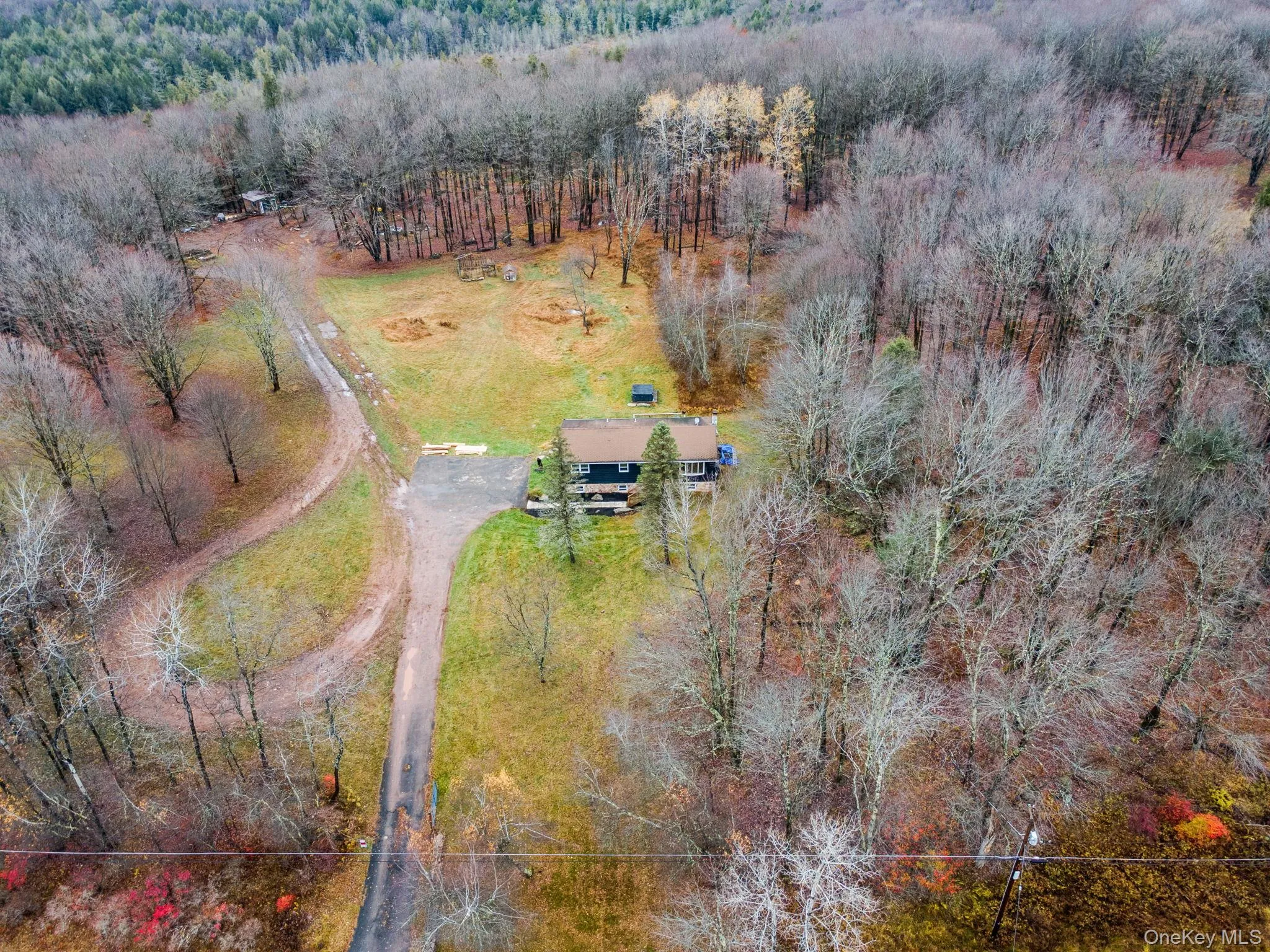 View from above of property with a heavily wooded area View from above of property with a heavily wooded area