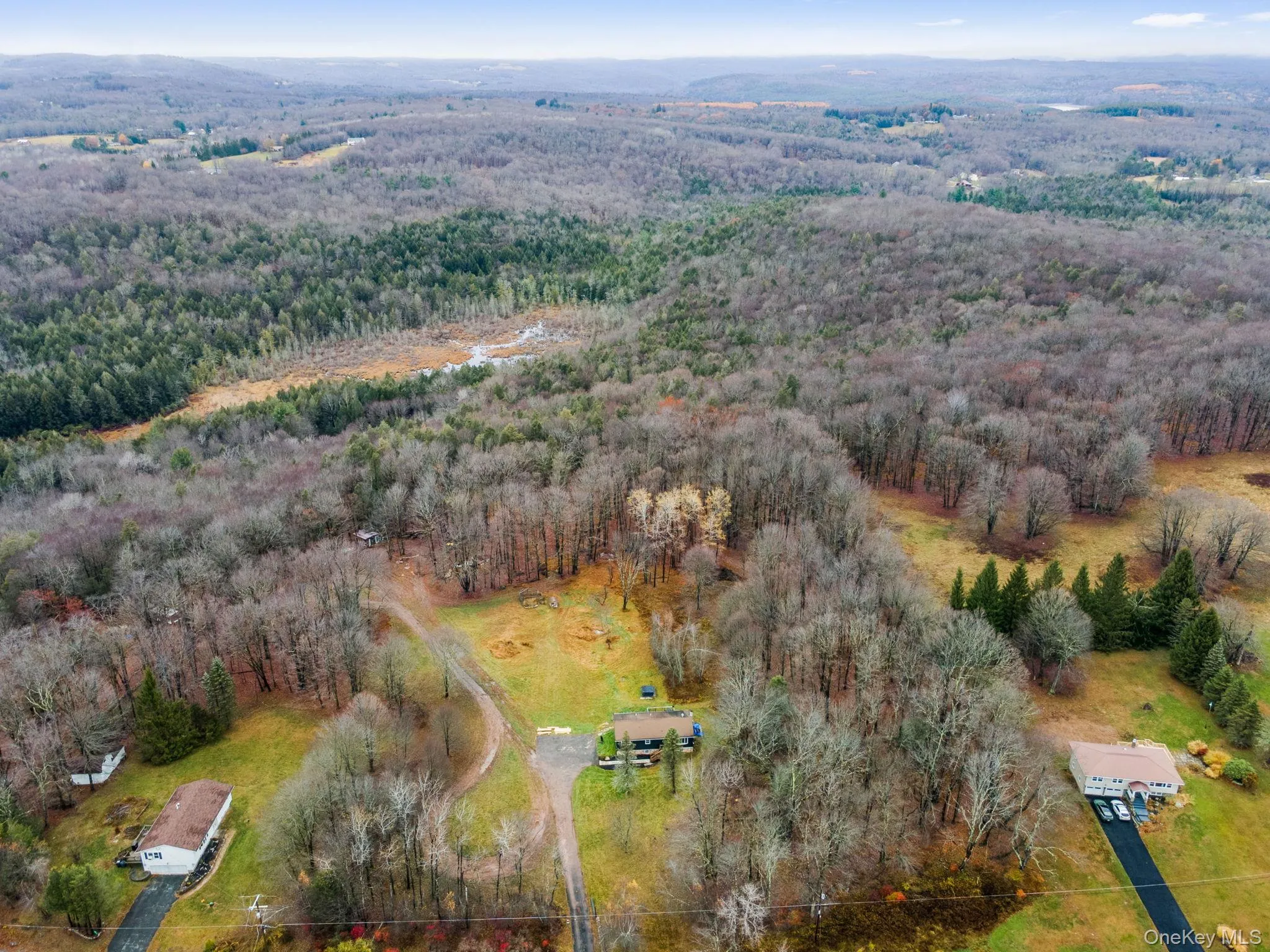 Aerial overview of property's location featuring a heavily wooded area Aerial overview of property's location featuring a heavily wooded area